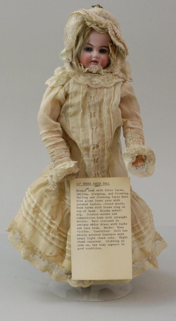 ANTIQUE BISQUE HEAD GERMAN DOLL.: 14" Three Faced Doll. Face 1) Sleeping. Face 2) Smiling. Face 3) Frowning. Two of the faces have stationary blue eyes, the other has closed eyes. They all have either open/closed or closed mouths. Blo