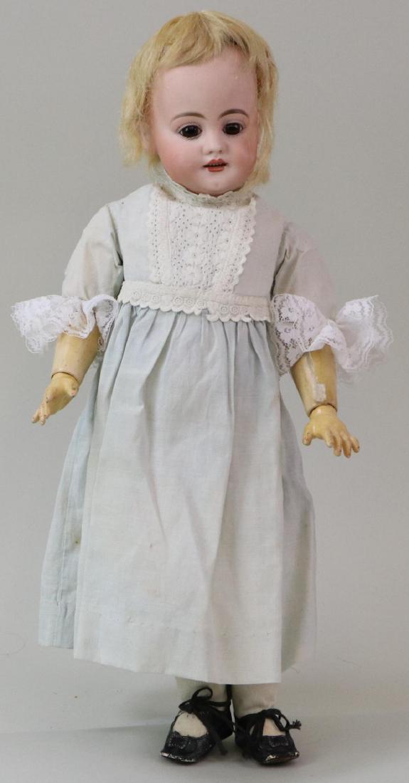 ANTIQUE BISQUE HEAD GERMAN DOLL.: 15" S 8 1/2 H 739 DEP doll with stationary brown eyes, open mouth, blonde mohair wig, plaster pate. Papier mache ball jointed body. Dressed in vintage cotton dress, pantaloons. No petticoat. Black lea