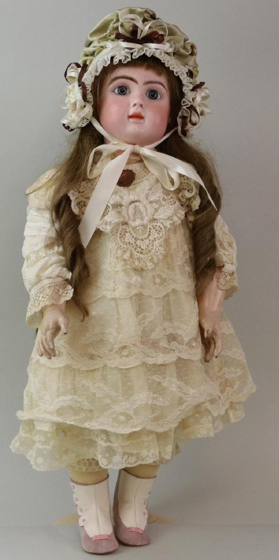 ANTIQUE BISQUE HEAD FRENCH DOLL.: 28" (STEINER) A 19 (black stamp) LeParisien Bte. S.G.D.G. 19 doll with blue paper weight eyes, closed mouth, pierced ears, long brown curly human hair wig. Papier mache jointed body marked (blue stamp