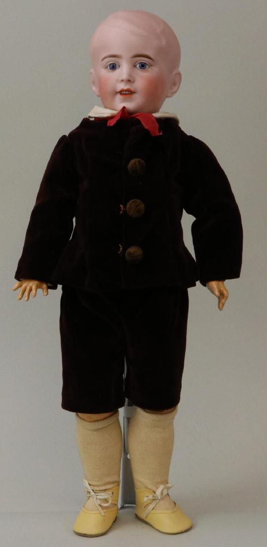 ANTIQUE BISQUE HEAD FRENCH DOLL.: 19" S.F.B.J. 237 PARIS 6 character boy doll with solid dome head. Stationary blue eyes, open mouth, very pale blonde painted hair. Papier mache jointed body. Dressed in vintage brown velvet jacket and