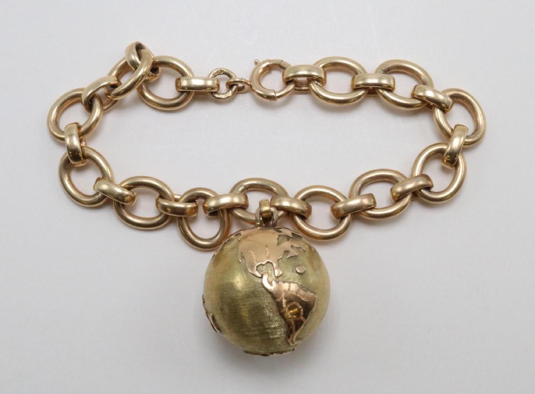 Bracelet. 18K Yellow and Rose Gold Earth Globe Charm on: Bracelet. 18K Yellow and Rose Gold Earth Globe Charm on 14K Yellow Gold Link Chain 7" long 14KY bracelet: 28.6gtw. Features (1) 22mm round 18KYÂ brushed gold Globe with polished Rose gold continents