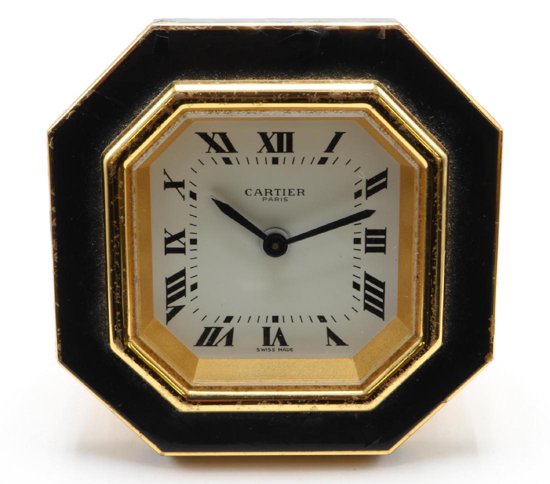 Les Must De Cartier. Desk Travel Alarm Clock: 3 - 3 1/4" diameter Hexagon. Black enamel shows wear.and crazing. 7507 06890. Comes with case and box.