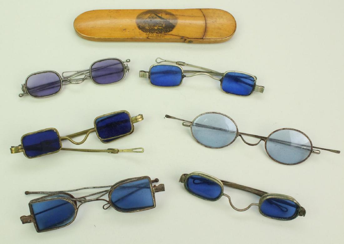 Grouping of 19th Century Eyeglasses-Blue or Violet: Grouping of seven 19th century eyeglasses with blue or violet lenses including; 1.) Plated brass frames with blue oval lenses (double lenses Richardson type), telescopic temples and teardrop loop temp