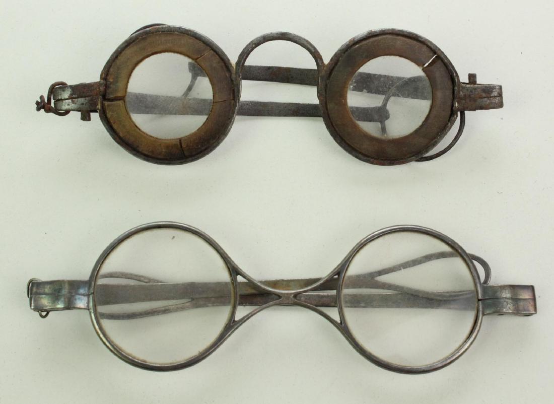 Late 18th/Early 19th Century Eyeglasses: Late 18th/early 19th Century eyeglasses including ; 1.) Steel frames with round lenses presenting Martin's Margins made of horn, straight temples and large round loop temple finials. 2.) Steel frames