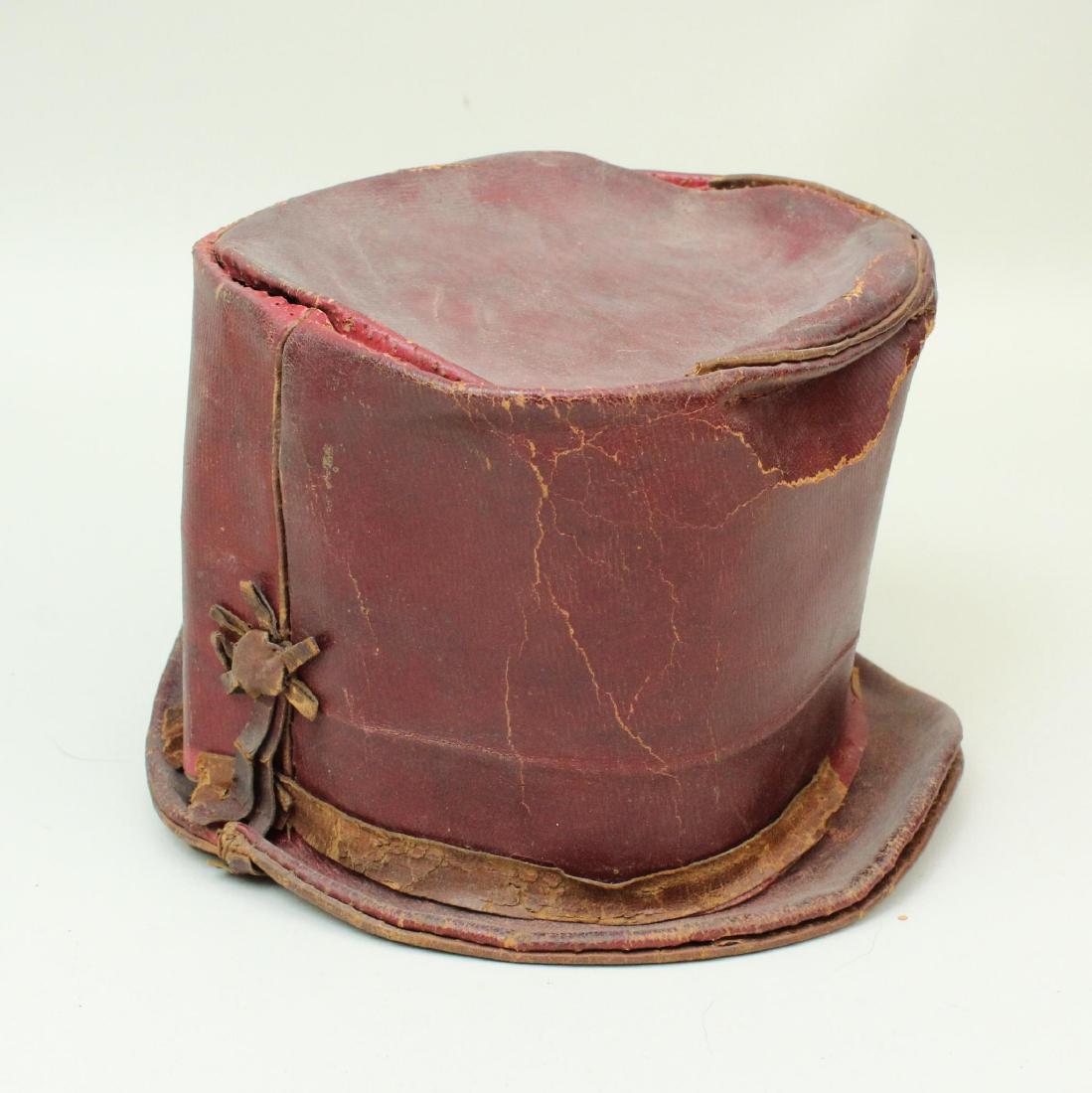 19th Century Leather Boy's Hat: Red leather early 19th century boy's hat presenting interior paper label from "Lee Brown's Wholesale & Retail Ladies & Gentlemen's Hat Warehouse and Split Straw, Leghorn, Chiphat & Bonnet Manufactory,
