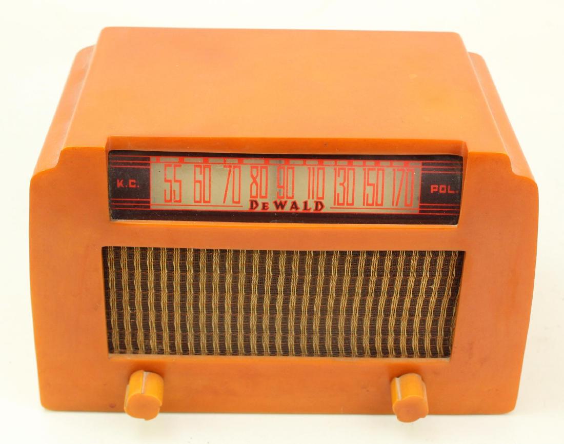 DeWald Catalin Radio: Model A-502. Caramel Radio with cloth grill. No visible cracks on body. Cord intact. Powers on.
