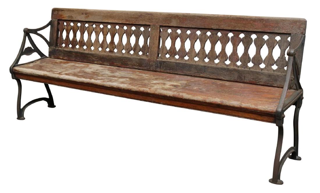 Trolley Bench: Wrought iron frame with an oak pierced splat and seat. Swivel back for forward and rear facing. 32”h x 81”w x 15”d