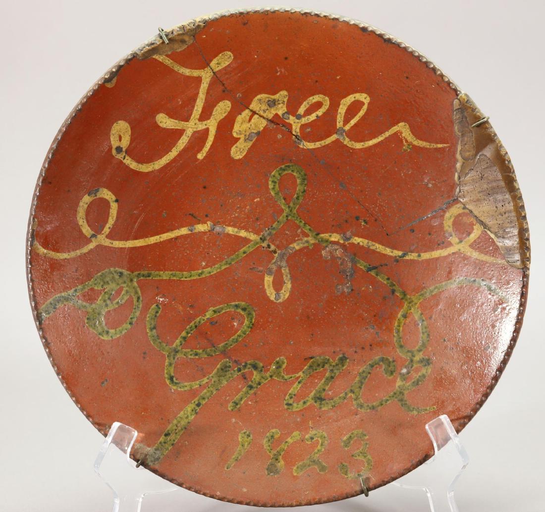 19th c. Slipware Plate: 13"round redware plate with yellow and green slip decoration. Dated 1823. Has multiple repairs