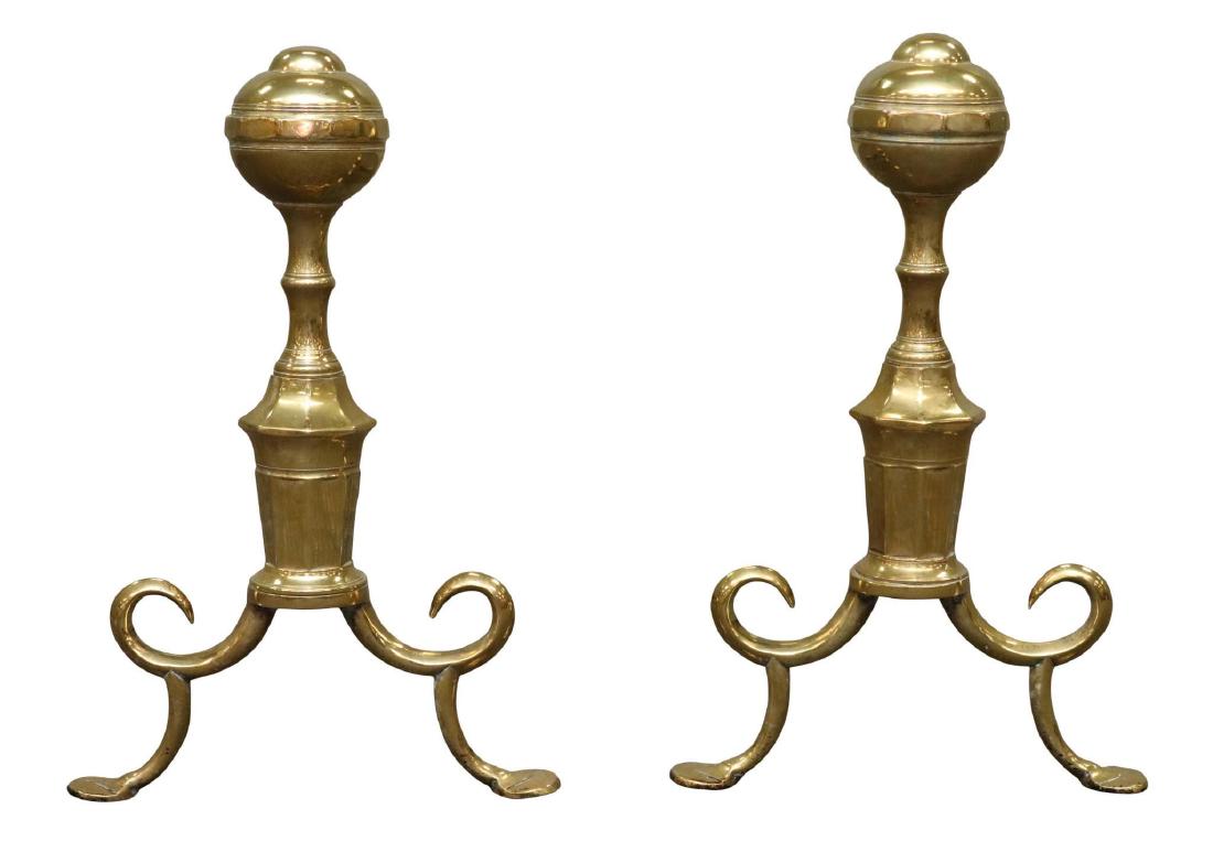 Pair of Federal Brass Andirons: Circular and turned columns on curled spurred cabriole legs and flat feet. 18”h x 12”w x 20”d