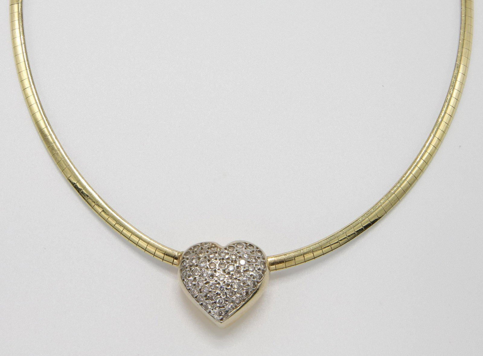 14K Gold Reversible Heart Diamond Necklace: 15" long, 3.2mm wide omega with 14KY magnetic clasp. Reversible: white gold omega features a 17.8mm polished yellow heart pendant / yellow gold omega features reverse of heart pendant set with round D