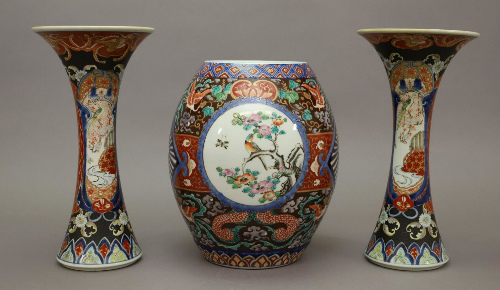 Japanese Porcelain Vase Grouping: 1850-1900, pair of flared beaker vases and a dark ground ovoid vase, signed Hichozan. 12.25"h and 10.5"h