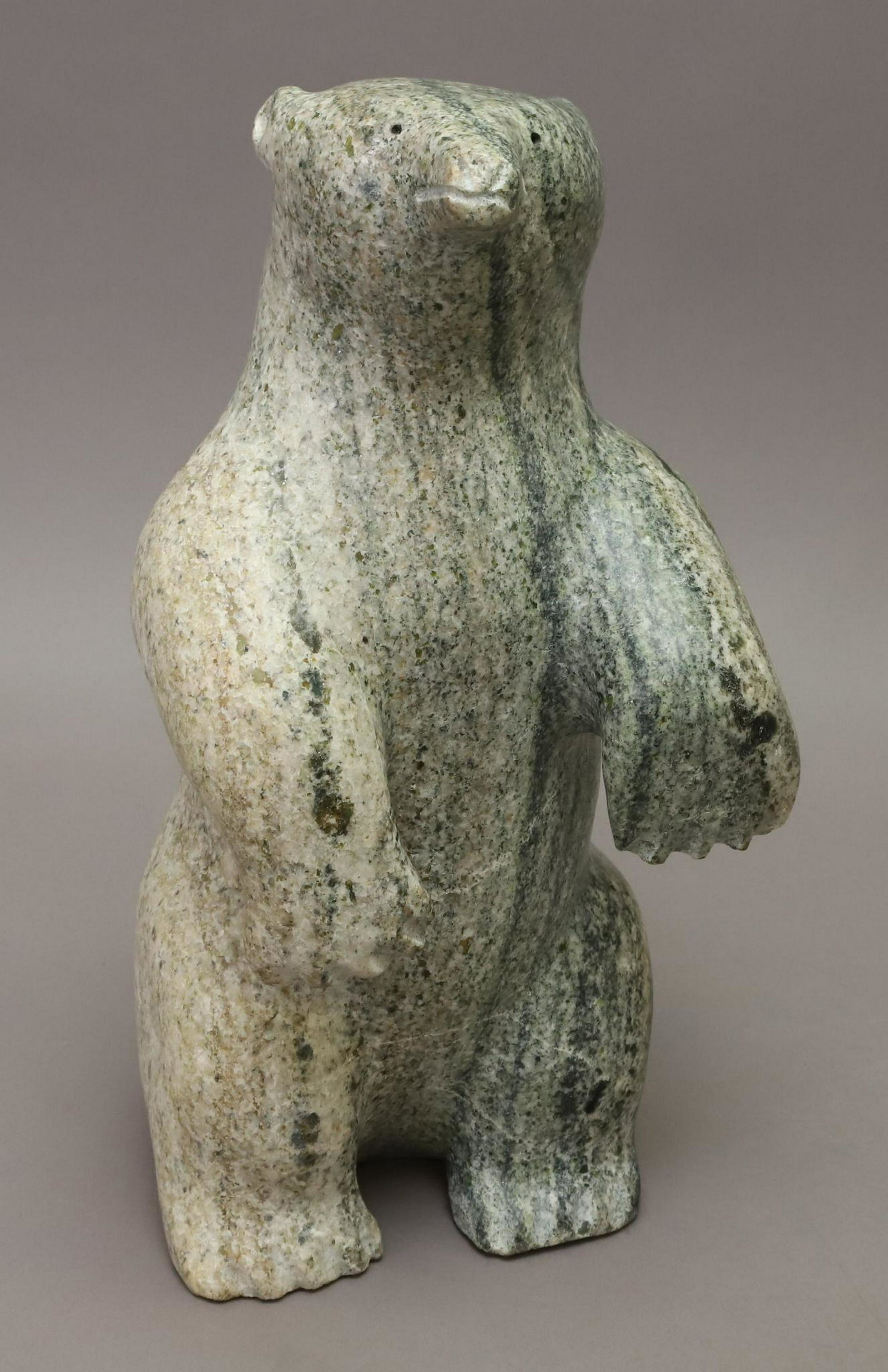Large Inuit Carving: Hand carved bear sculpture by Ilkoo Angutikjuak from Baffin Island marble. 14"h x 7"w x 7"d