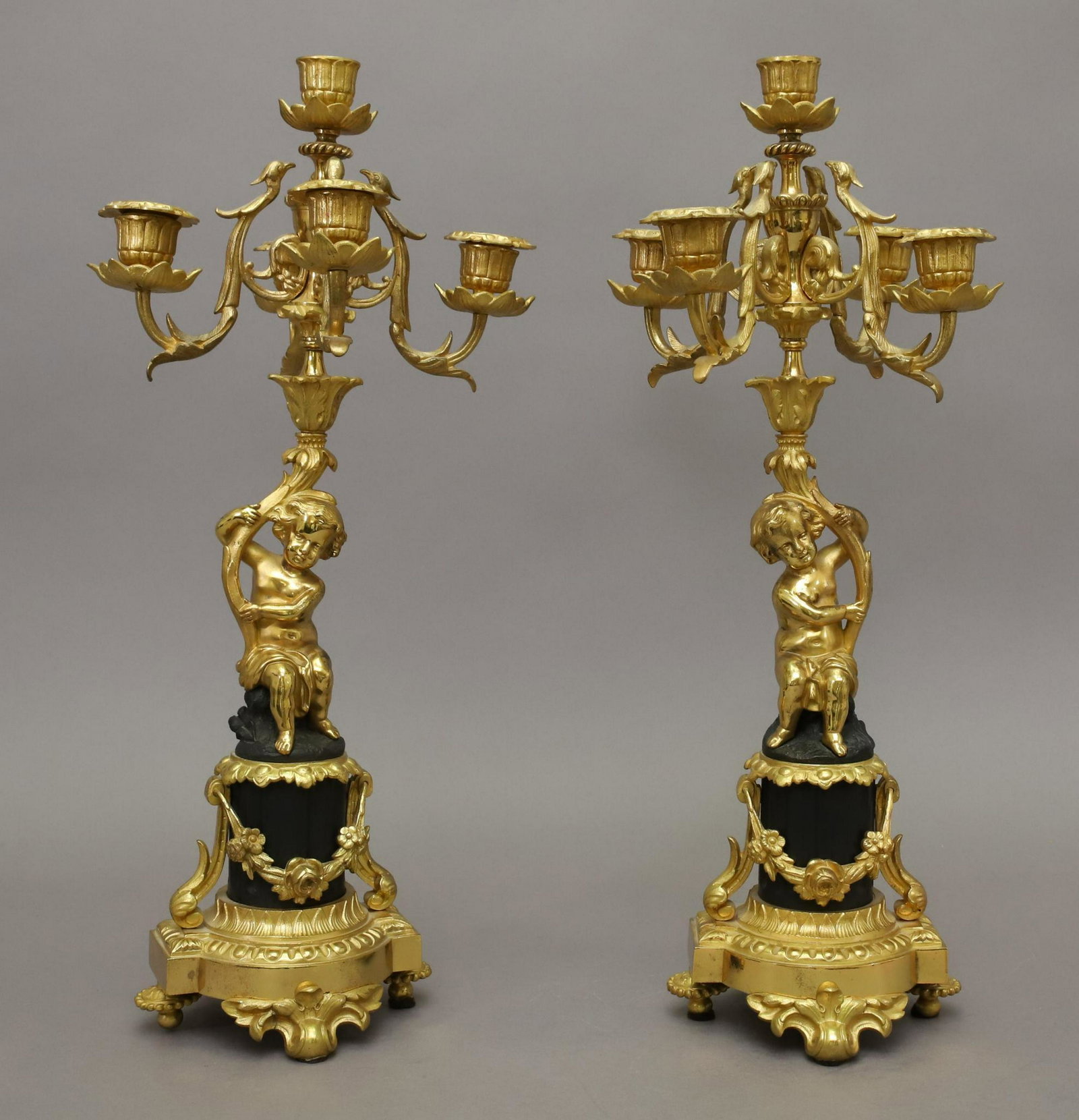 Louis XVI Style Candelabra: Patinated bronze and ormolu candelabra with putto. 18"h x 8.5"w