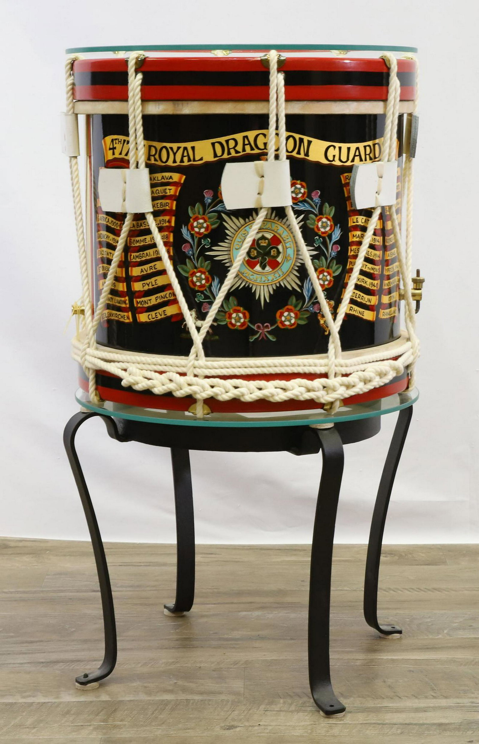 British Military Side Drum-4th/7th Royal Dragoon Guards: Brass bodied British military side drum for the 4th/7th Royal Dragoon Guards measuring 14" in height and 14.5" in diameter. Drum features hand painted coat of arms for regiment flanked by battle honor