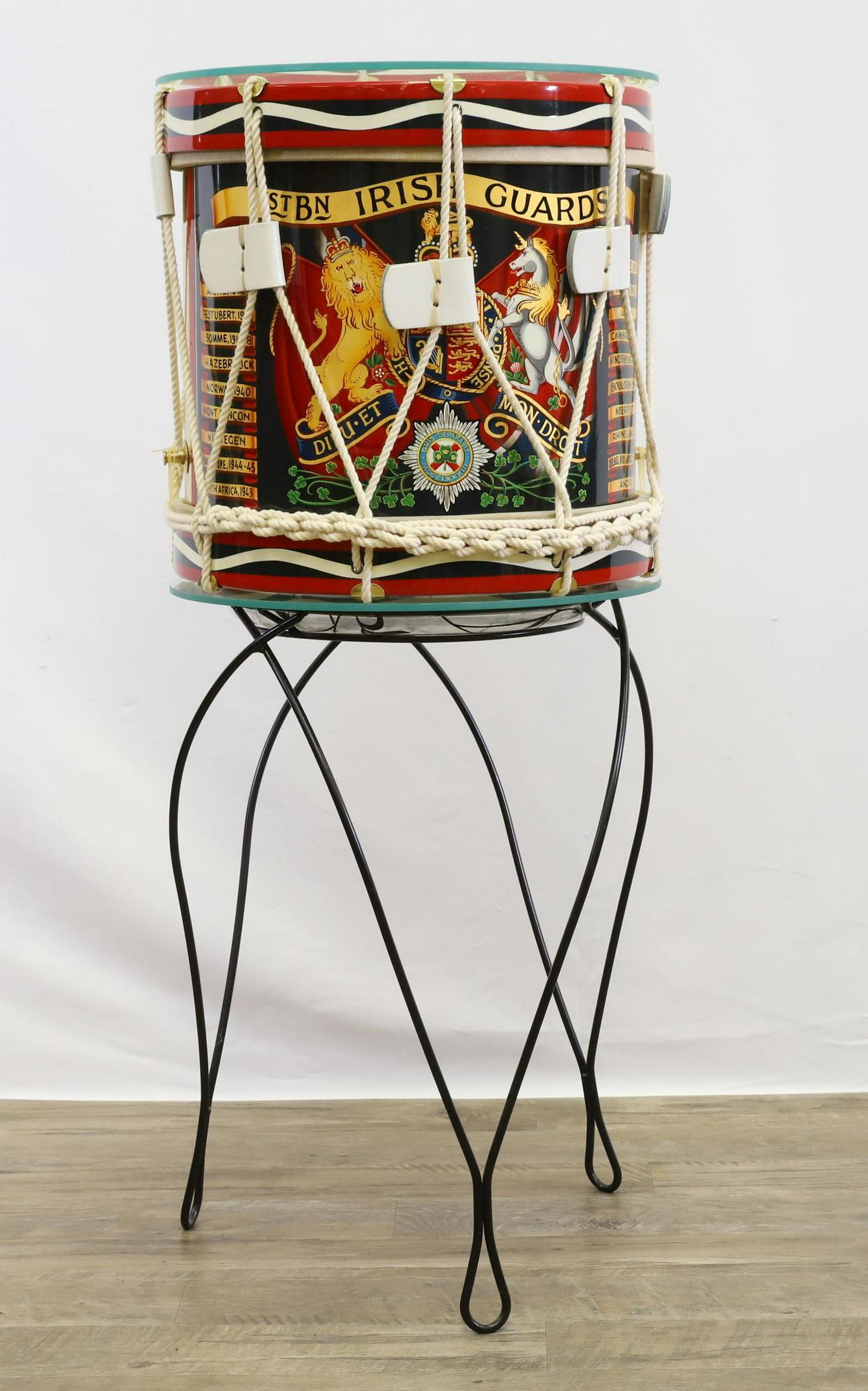 British Military Side Drum-1st Battalion Irish Guards: Brass bodied British military side drum for the 1st Battalion Irish Guards measuring 14.5" in height and 14.5" in diameter. Drum features hand painted coat of arms for regiment flanked by battle honor