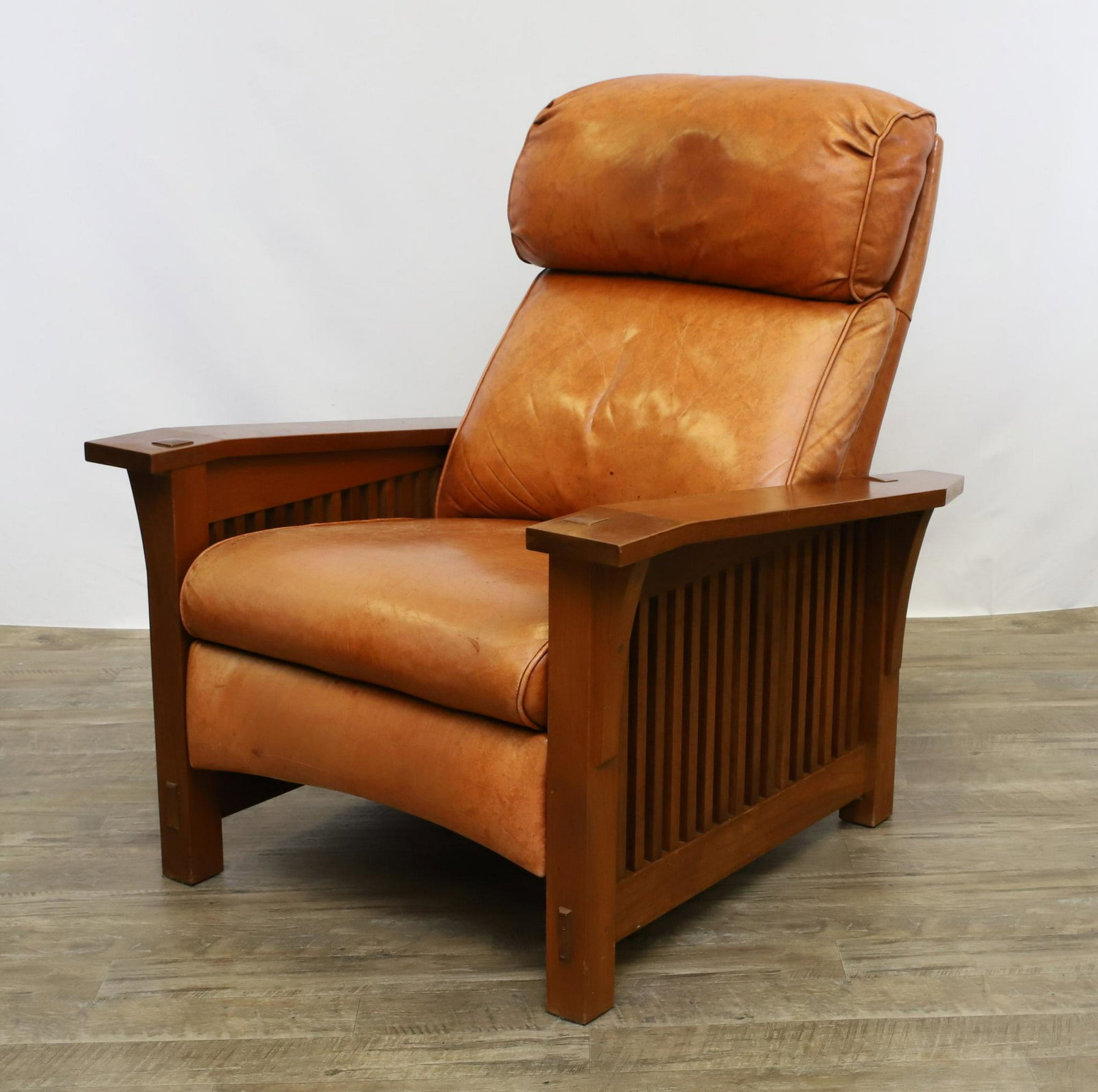 Stickley Spindle Morris Recliner: No. 369RL. Solid cherry frame with straight back leather cushion and canted arms. Staining to the leather. 40"h x 34"w x 37"d