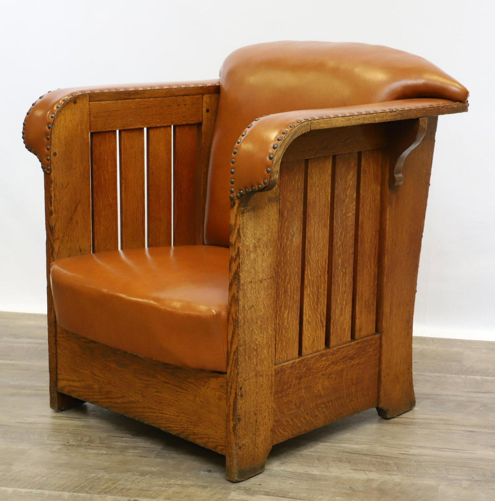 Karpen Arts and Crafts Mission Oak Club Chair: Light brown leather seat, back, and arms with nail heads and corbels. 34"h x 32"w x 24"d