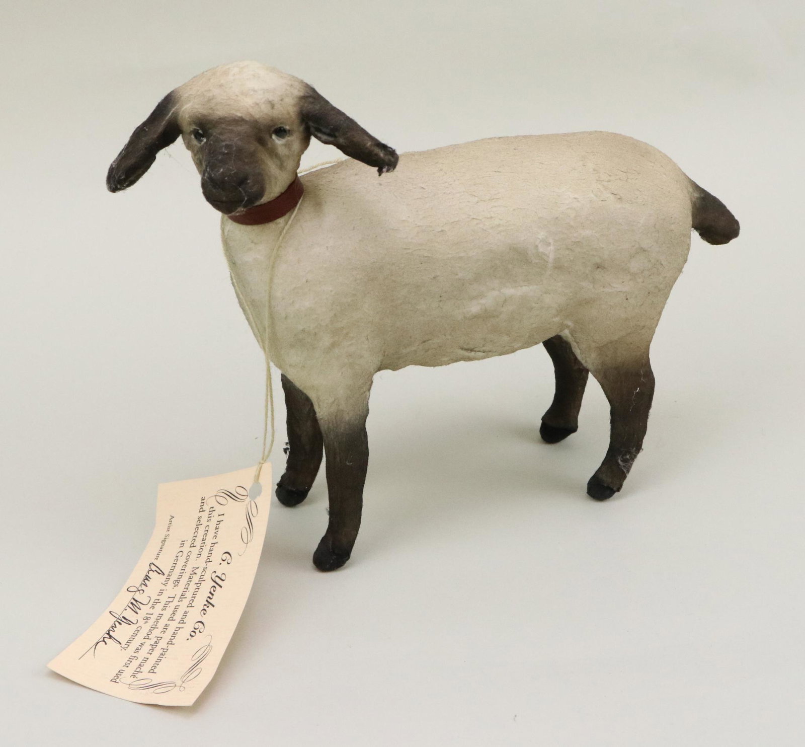 LOT OF ARTIST DOLL(S).: 7" T x 8 1/2" L "Standing Lamb" made by artist Craig M. Yenke. Papier mache with batting covering. Stationary eyes. Animal is marked by both cloth tag and a hang tag.