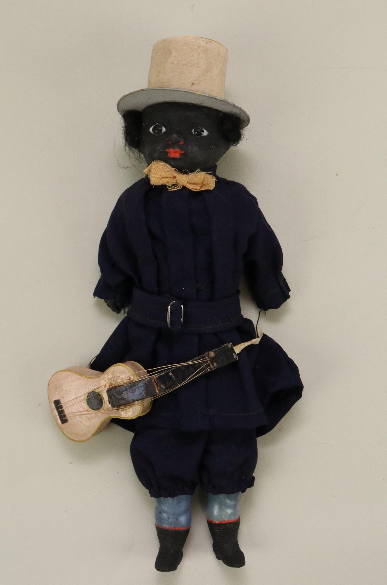 LOT OF HOLIDAY/NOVELTY.: 11" All original German papier mache Minstral doll with guitar. Papier mache shoulder head, arms, legs. Cloth body. Stationary glass eyes, black mohair wig. Cloth covered papier mache top hat. Dressed