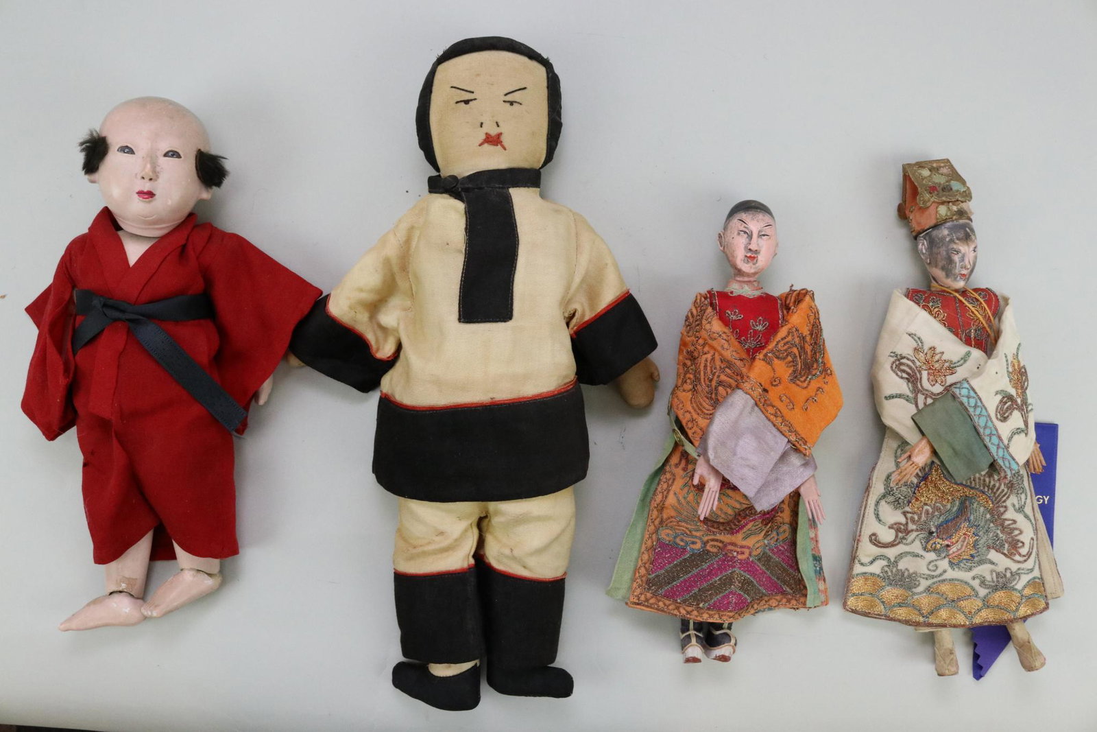 LOT OF DOLLS FROM OTHER COUNTRIES.: Lot of (4) Asian dolls. Pair of all original papier mache Chinese theatre dolls. Beautiful embroidered clothing. 11 1/2" Papier mache Japanese man. Stationary eyes, fur hair. Motchman body. 14" Cloth 