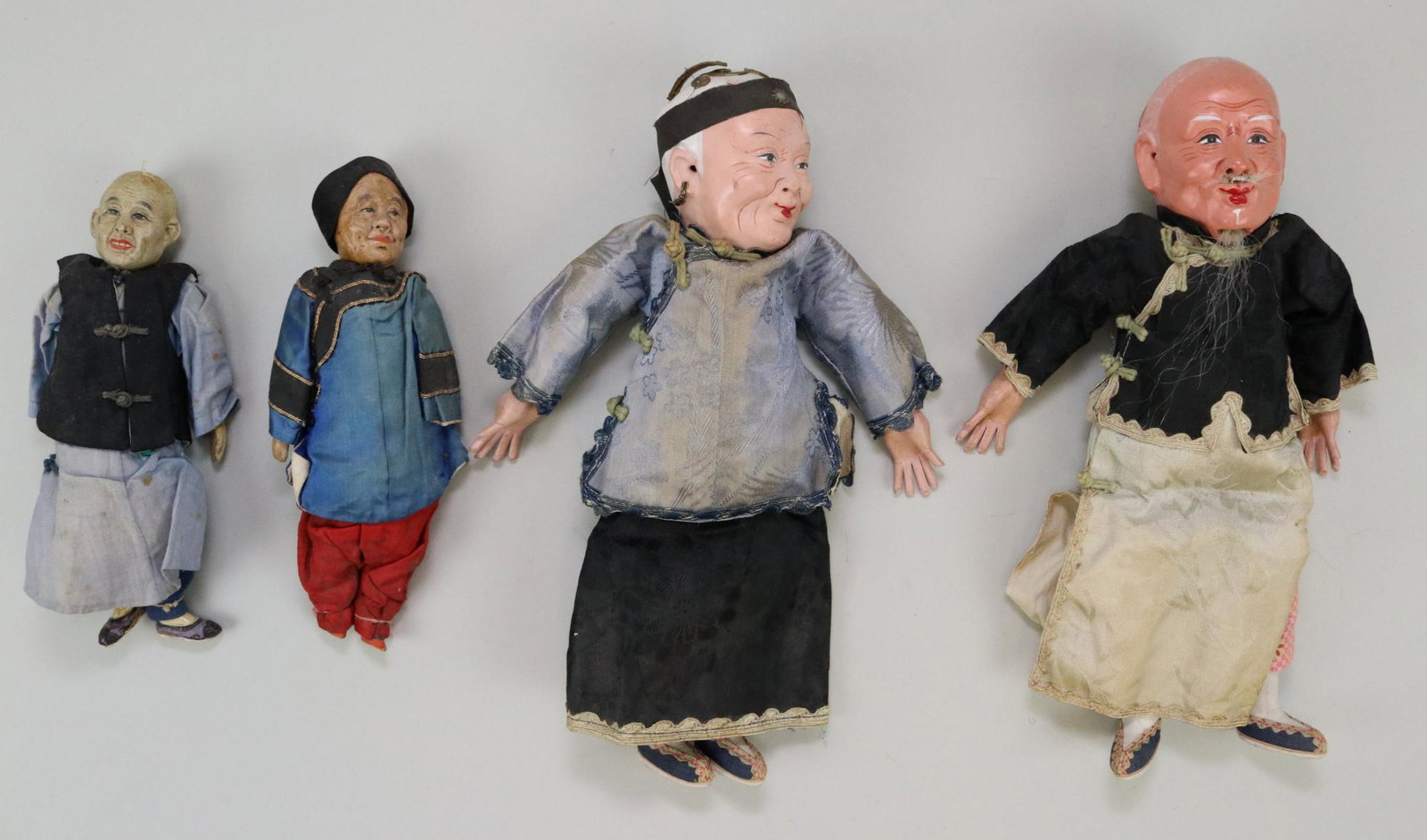 LOT OF DOLLS FROM OTHER COUNTRIES.: Lot of (4) all original Chinese dolls with papier mache/composition heads, cloth bodies, papier mache lower limbs. Two elderly couples: 9", 12" with painted features and hair. Silk and cotton clothing