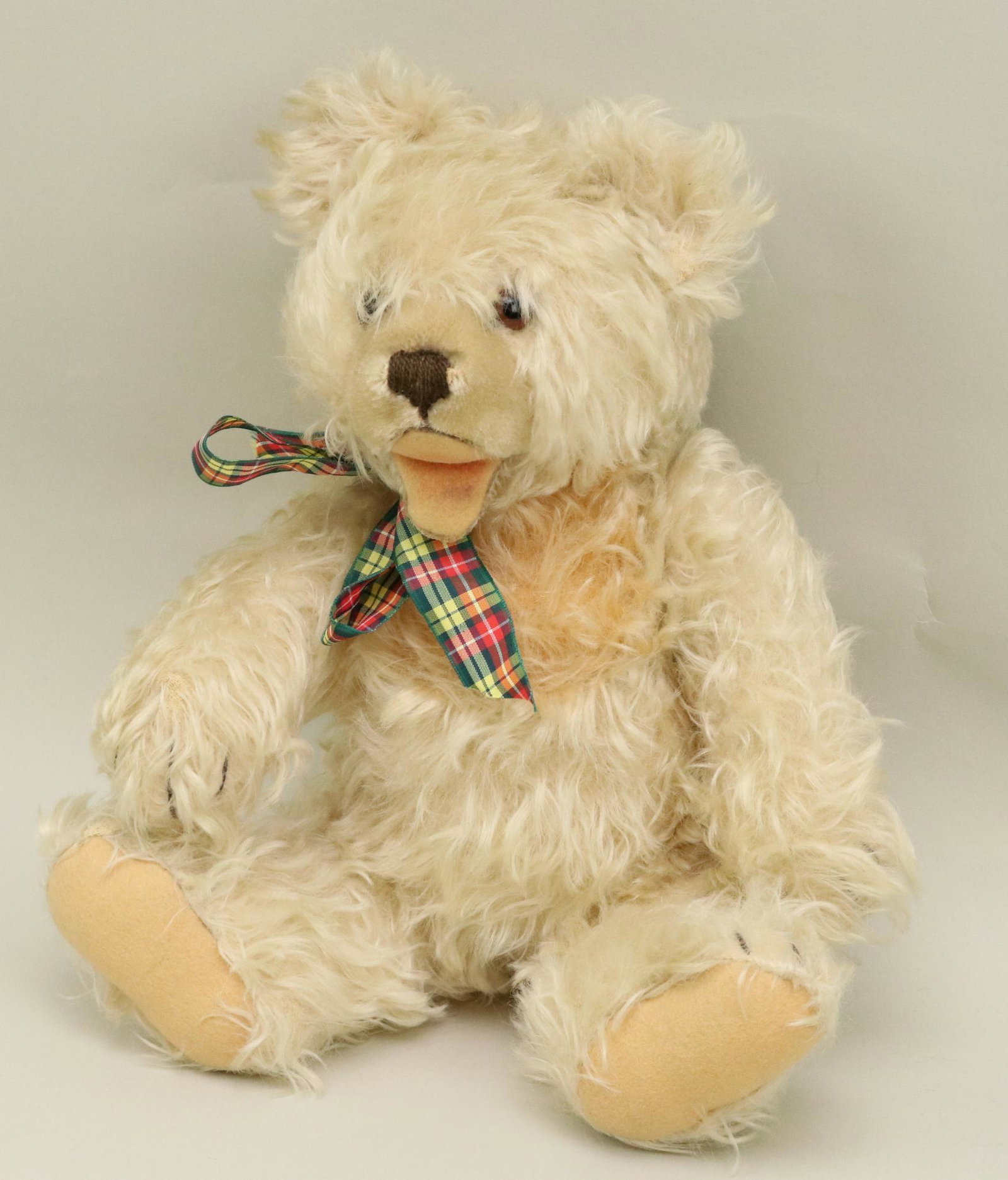 14" UNMARKED STEIFF "ZOTI" BEAR.: Ivory curly mohair with apricot bib. Clipped nose, open felt mouth. Brown glass eyes. Swivel head with fully jointed body. Condition: loss of mohair under mouth