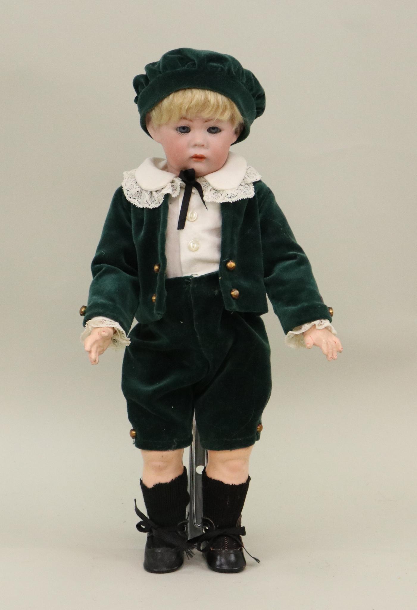 ANTIQUE BISQUE HEAD GERMAN DOLL.: 12 1/2" II K # R S & H 115/A character doll with blue sleep eyes, closed mouth, blonde mohair wig. Papier mache ball jointed toddler body. Dressed in a newer Little Lord Fauntleroy type outfit of gree