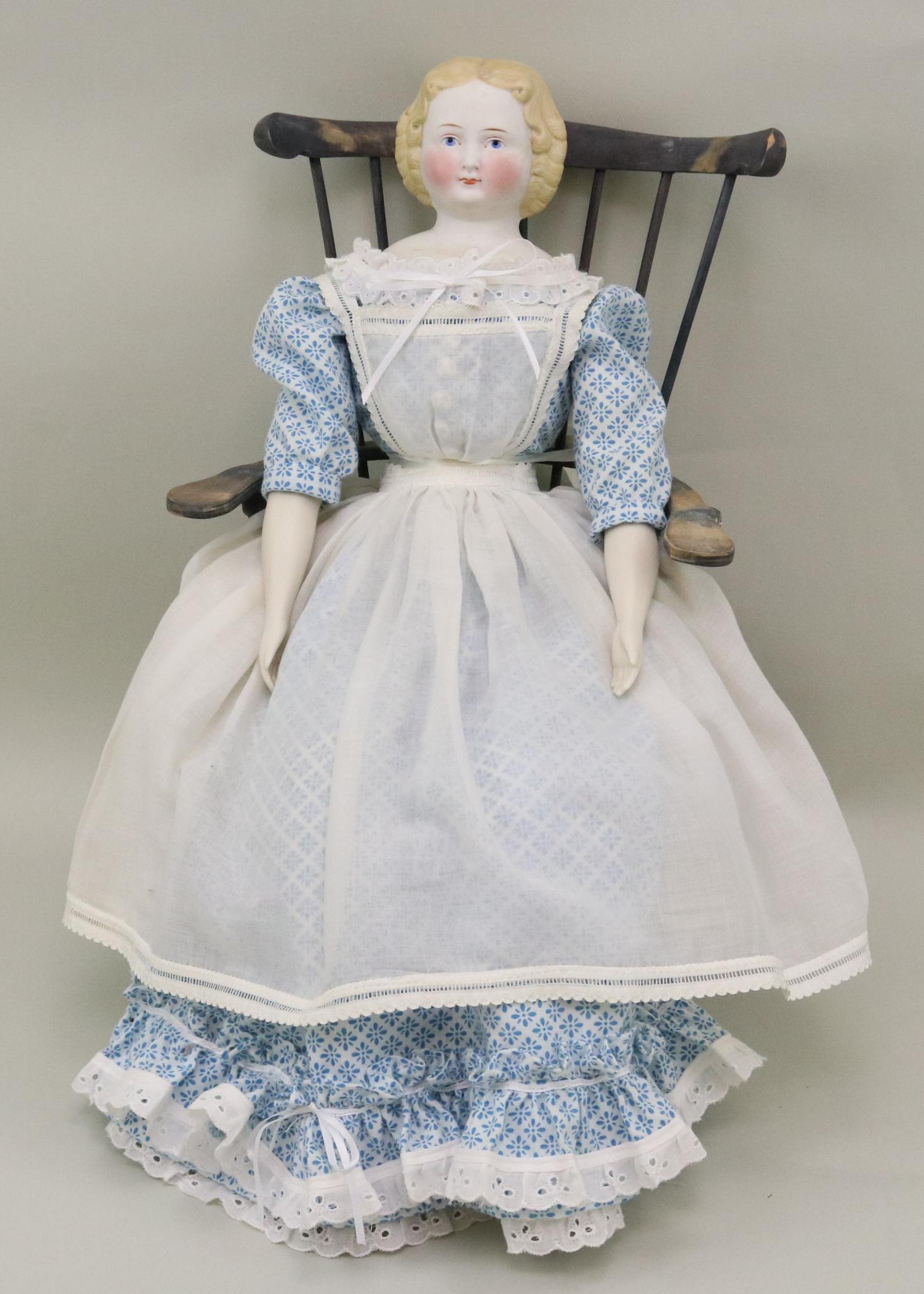 LOT OF CHINA, PARIAN DOLL(S).: 21" Unmarked antique Parian shoulder head with blonde center part hair, blue eyes, nice cheek coloring. Newer cloth body and parian/bisque lower limbs. Newer clothing. She sits on a reproduction woode