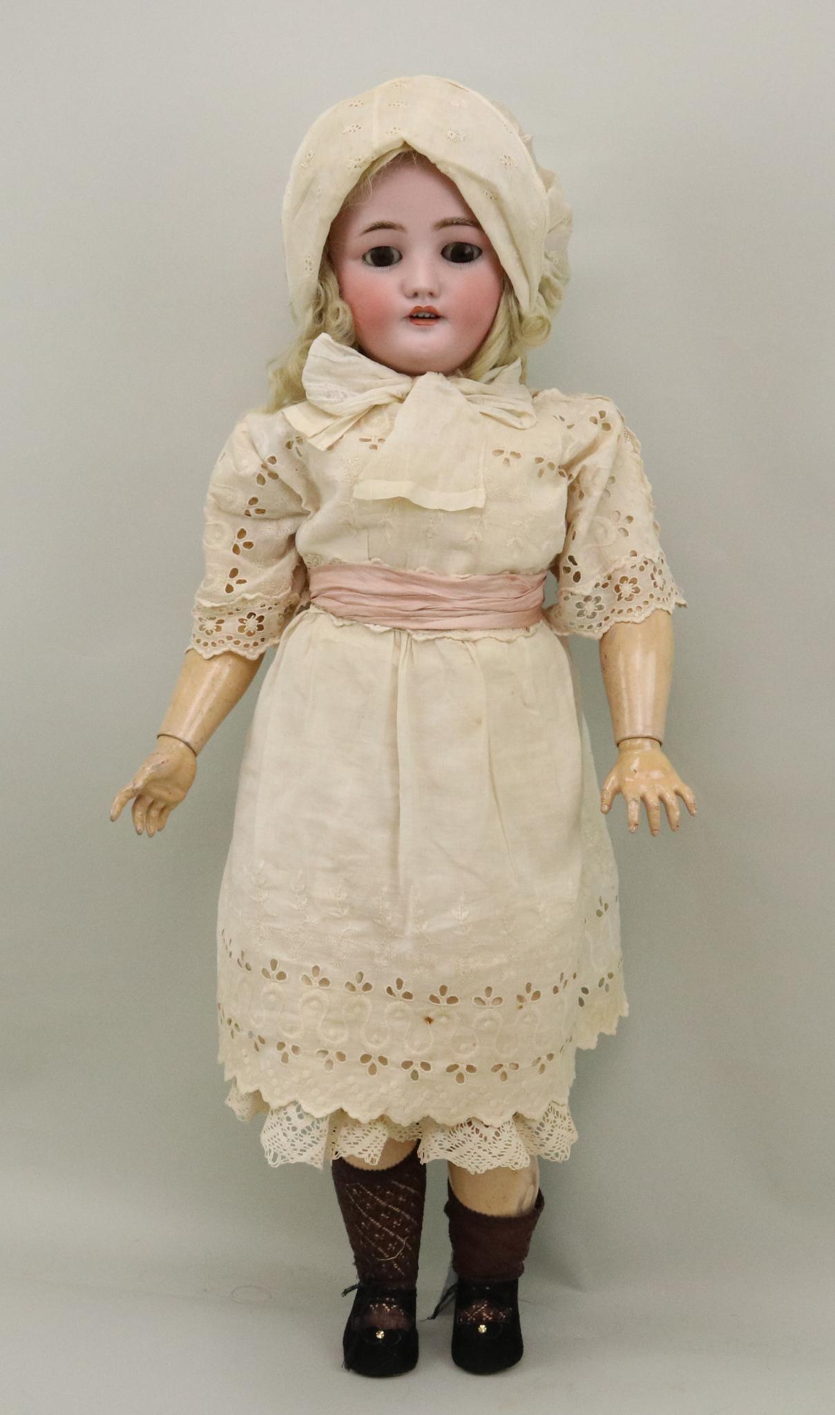 ANTIQUE GERMAN BISQUE DOLL.: 30" C.M. BERGMANN SIMON & HALBIG 13 1/2" doll with brown sleep eyes, open mouth, pierced ears. Blonde curly mohair wig. Papier mache ball jointed body. Dressed in all antique white cotton clothing: dr