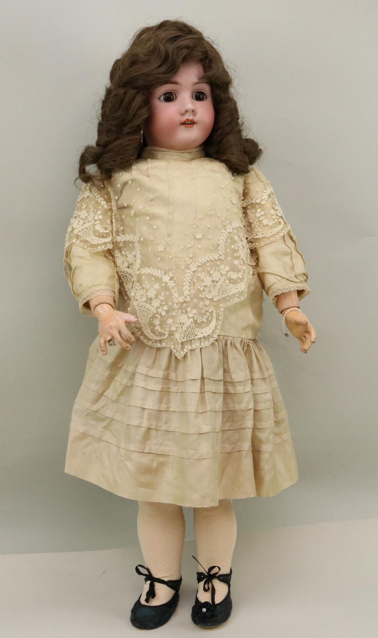 ANTIQUE GERMAN BISQUE DOLL.: 33" GERMANY HEINRICH HANDWERCK SIMON & HALBIG 7 doll with brown sleep eyes, open mouth, pierced ears, brown synthetic wig. Papier mache ball jointed body. Dressed in antique lace over rayon?/silk dres