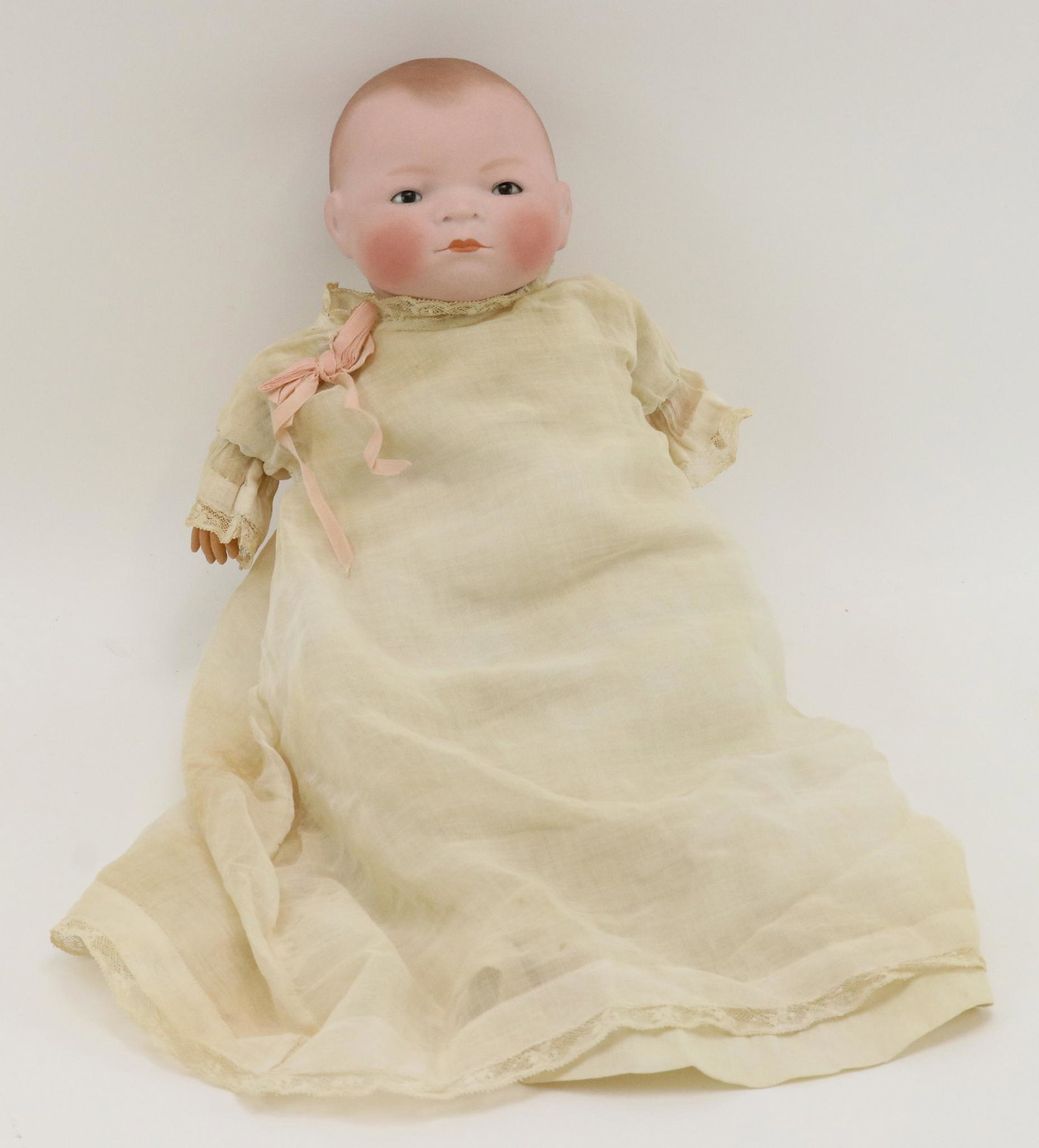 ANTIQUE GERMAN BISQUE DOLL.: This is an original owner doll. 15" L. 13" cir. COPR. BY GRACE S. PUTNAM MADE IN GERMANY "Byelo" baby doll with brown sleep eyes, painted light brown hair. Original cloth "frog" body is not marked. Ce