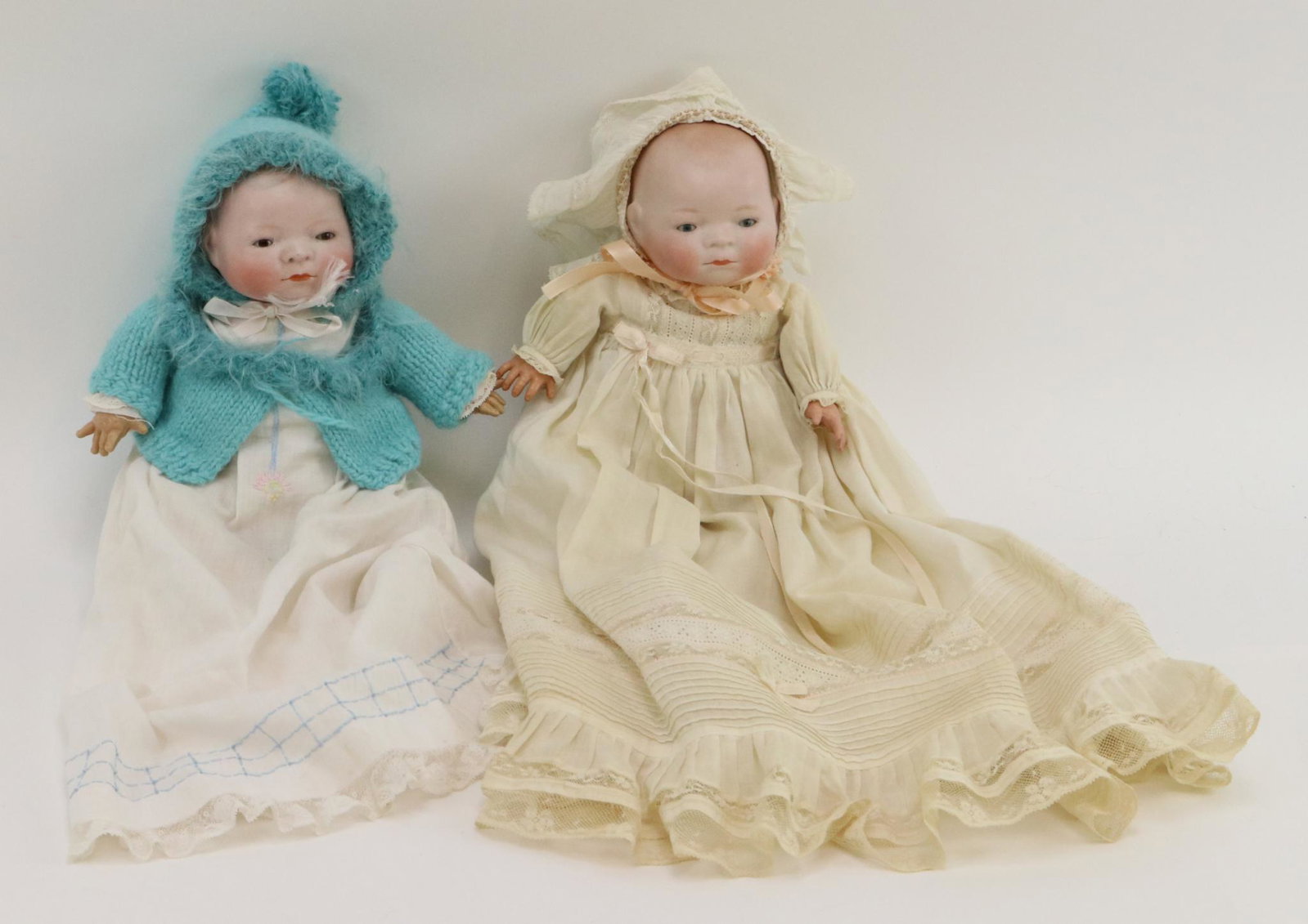 ANTIQUE GERMAN BISQUE DOLL(S).: Pair of 11" "Byelo" babies with 10" cir. heads. Copr. By Grace S. Putnam MADE IN GERMANY. Both have sleep eyes, closed mouths, light brown painted hair. Cloth "frog" bodies with celluloid hands. Doll 