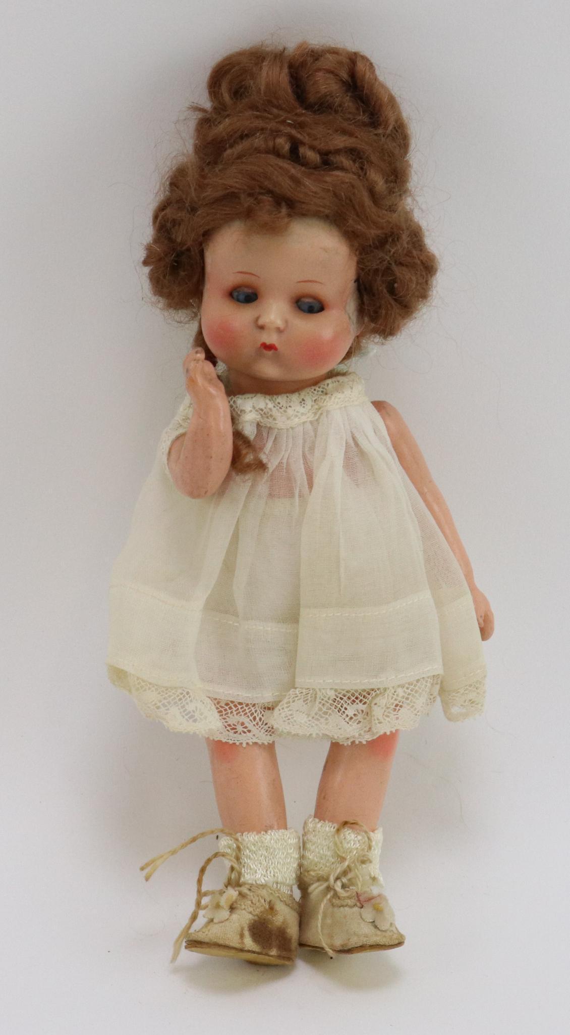 JUST ME DOLL.: 7" JustME Registered Germany A.310/11/0.M painted bisque head doll with blue side glance eyes, closed mouth, fancy brown mohair wig. 5 Pc. composition body. Dressed in white organdy dress, Blue oilclo