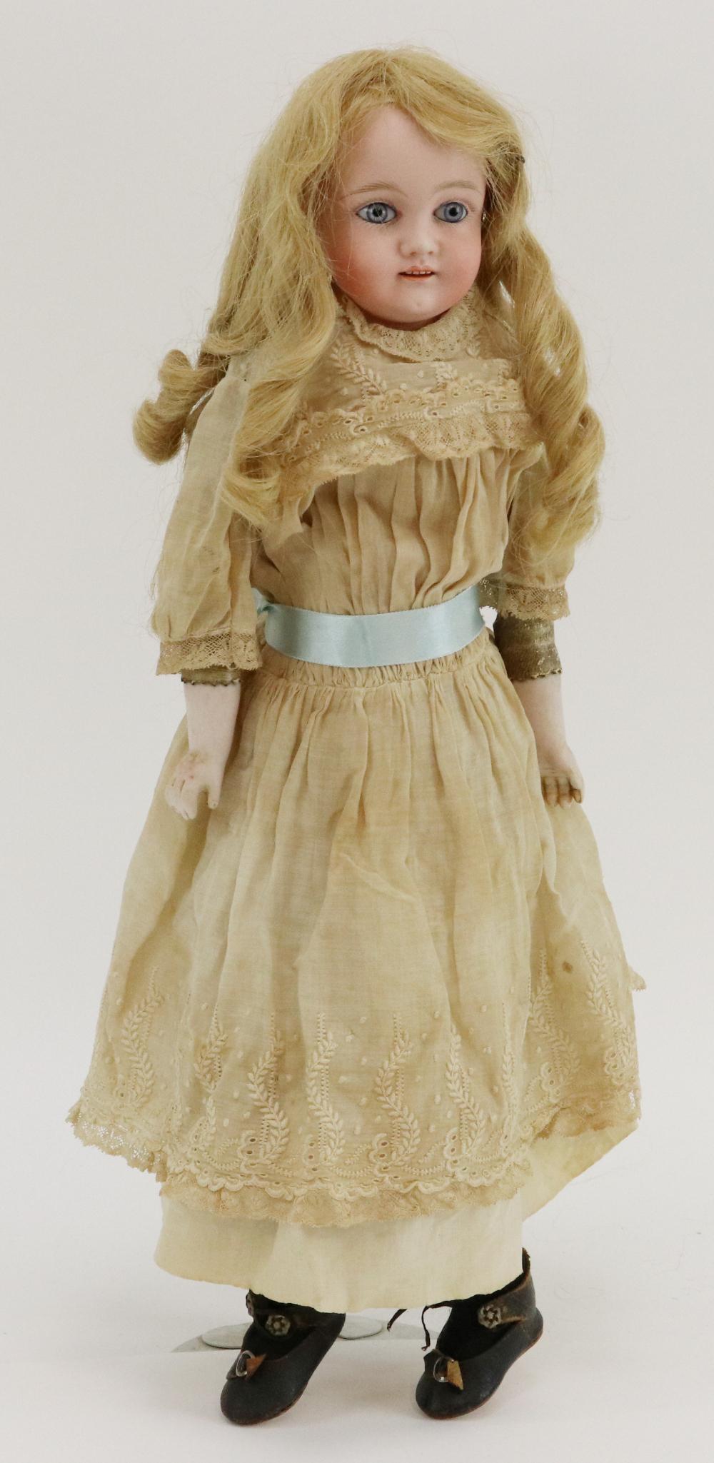 ANTIQUE GERMAN BISQUE DOLL.: 17" "6" Shoulder head doll with stationary blue eyes, open mouth, honey blonde human hair wig, plaster pate. Leather gussetted body with bisque lower arms. Dressed in all white cotton clothing: dress