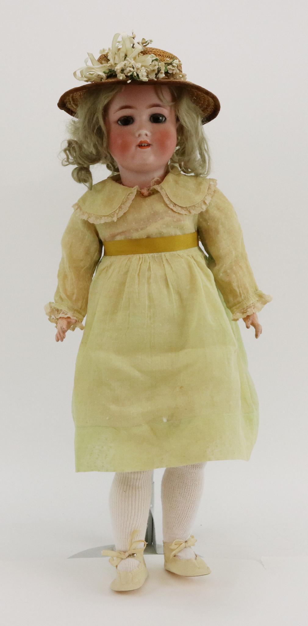 ANTIQUE GERMAN BISQUE DOLL.: Original owner doll. 24" C. M. BERGMANN S&H 3 doll with brown sleep eyes and fluffy lashes, open mouth, blonde mohair wig. Papier mache ball jointed body. Dressed in antique clothing - dotted Swiss dr