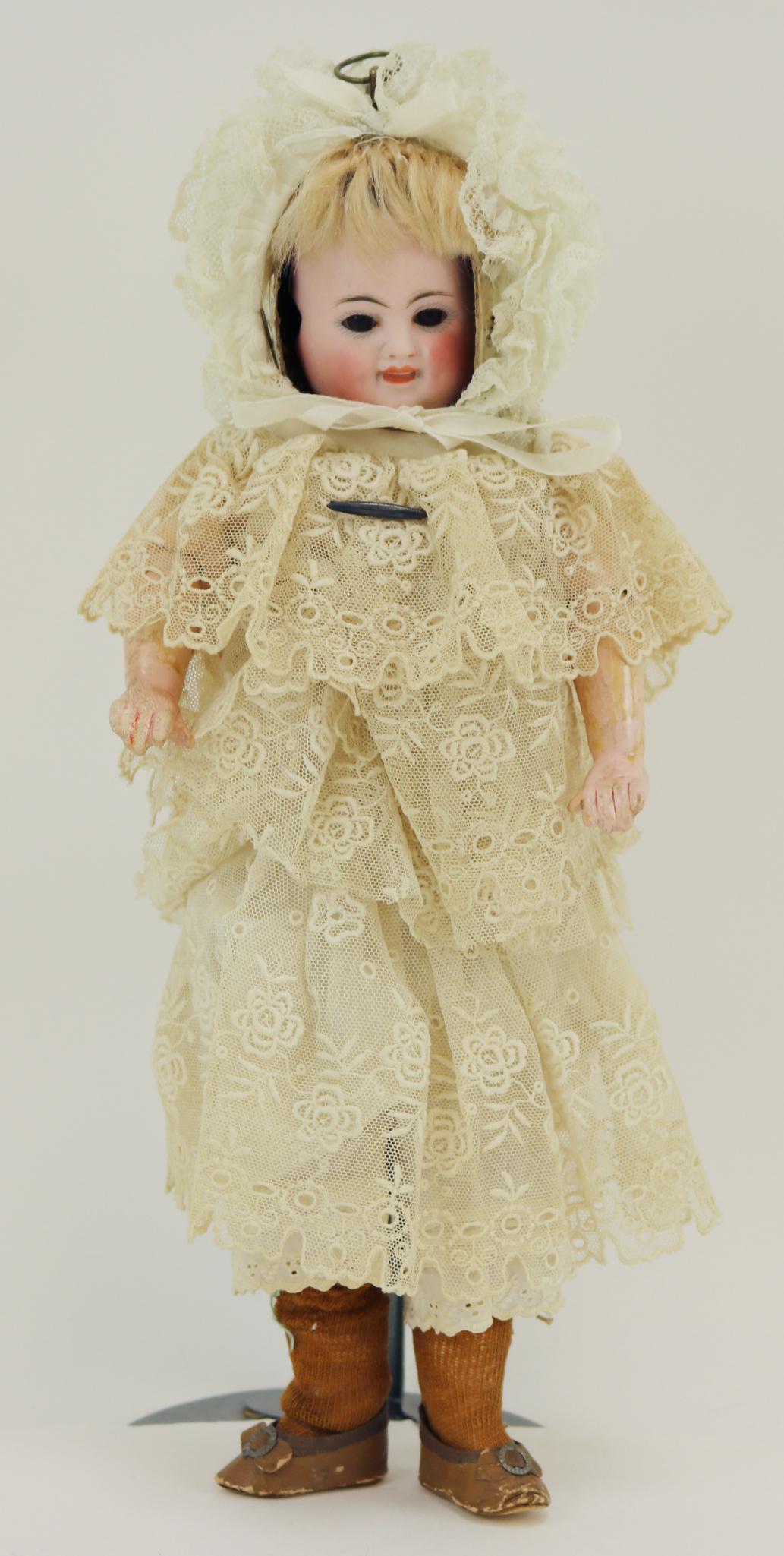 ANTIQUE GERMAN BISQUE DOLL(S), 12" AND UNDER.: 12" C.B. Three face doll: smiling, sleeping and crying. Stationary brown eyes on two of the faces. Blonde mohair wig under papier mache hood attached to shoulder plate (marked C.B. in circle) Cloth to