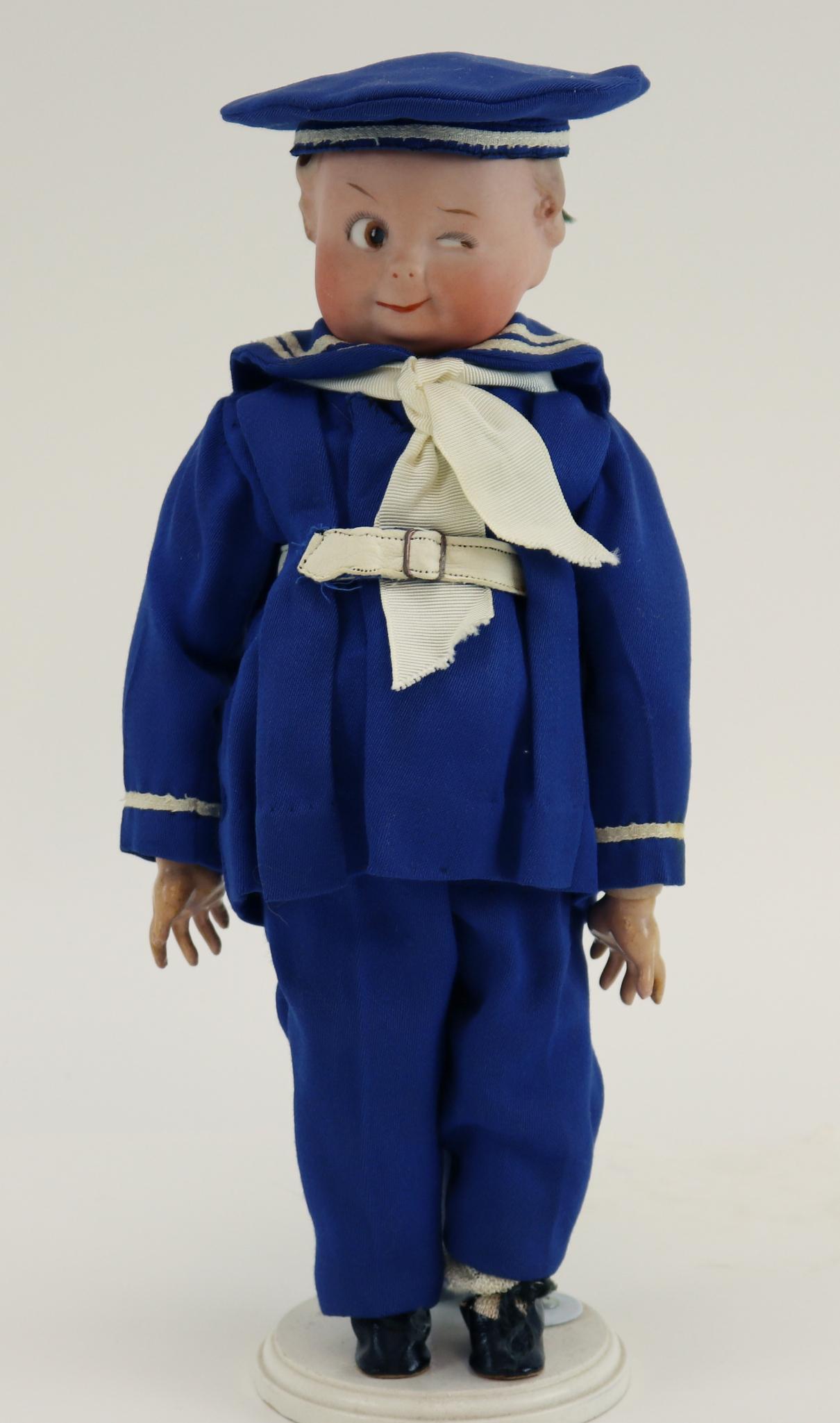 ANTIQUE GOOGLY DOLL(S).: 12" 1 HEUBACH (square) GERMANY solid dome bisque head character doll 9141 "The Winker". Brown integlio eye, watermelon smile, blonde painted hair. Papier mache jointed body. Dressed in newer blue sail