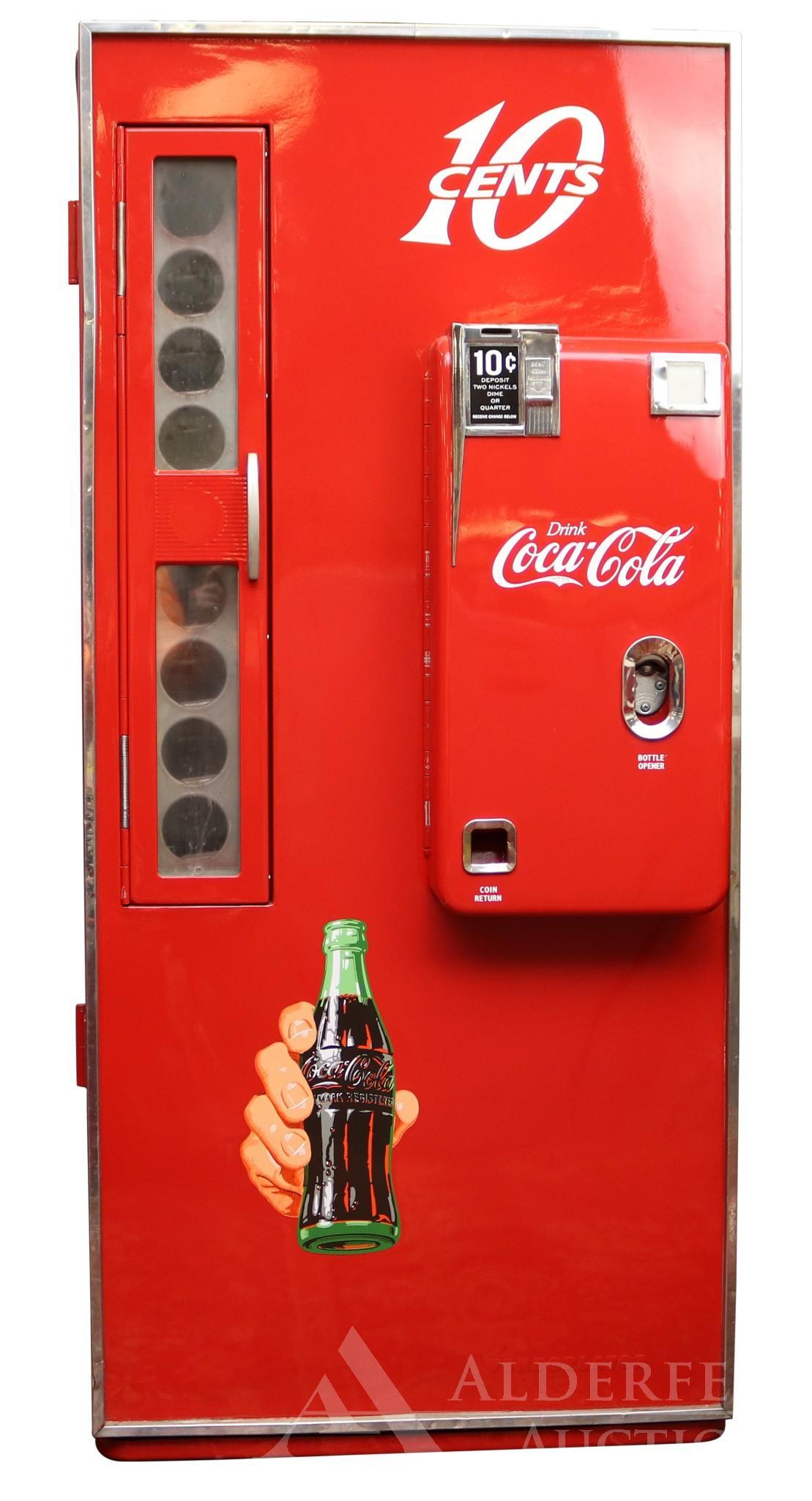 Vendolator 81 Coca-Cola Machine: Restored red transitional 81 Vendolator Coca-Cola machine with decals. ID plate with model and serial numbers. Measures 26"w x 22"d x 59"h. The Alderfer Shipping Department is not able to ship the maj