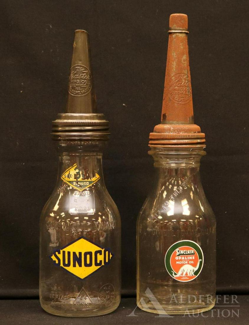 Glass Motor Oil Bottles: Two glass motor oil bottles, one with Sinclair label and the other Sunoco label. Tallest measures 14.25"H.