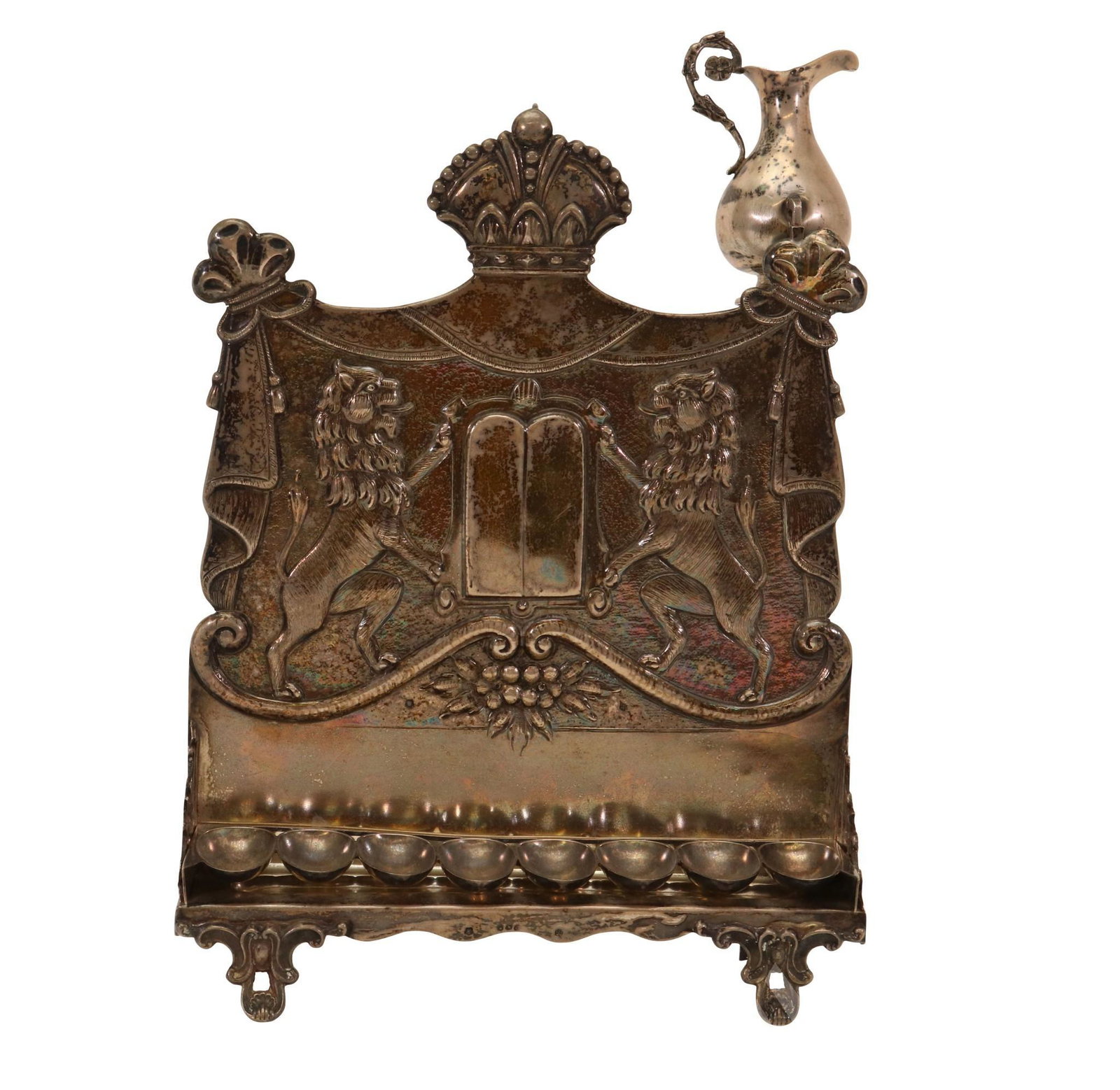 Austrian 800 Silver Oil Menorah: Late 19th/Early 20th c., embossed with crown finial and lions flanking non-engraved ten commandments, with complementing oil ewer. Austrian silver hallmarks on both pieces. 11"h x 8"w x 2.5"d 17.5oz