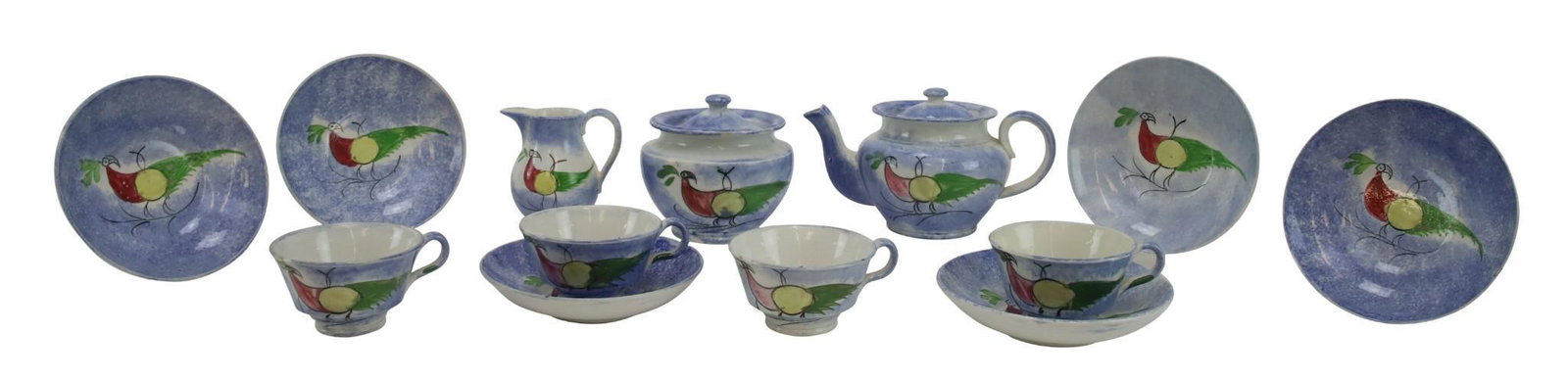 Blue Spatterware Tea Set: Child's blue spatterware tea set in the peafowl pattern, including teapot, creamer and sugar, (4) teacups and (6) saucers.19th century, England. Largest teapot measures 3.75"h. Saucer measures 1"h x 4