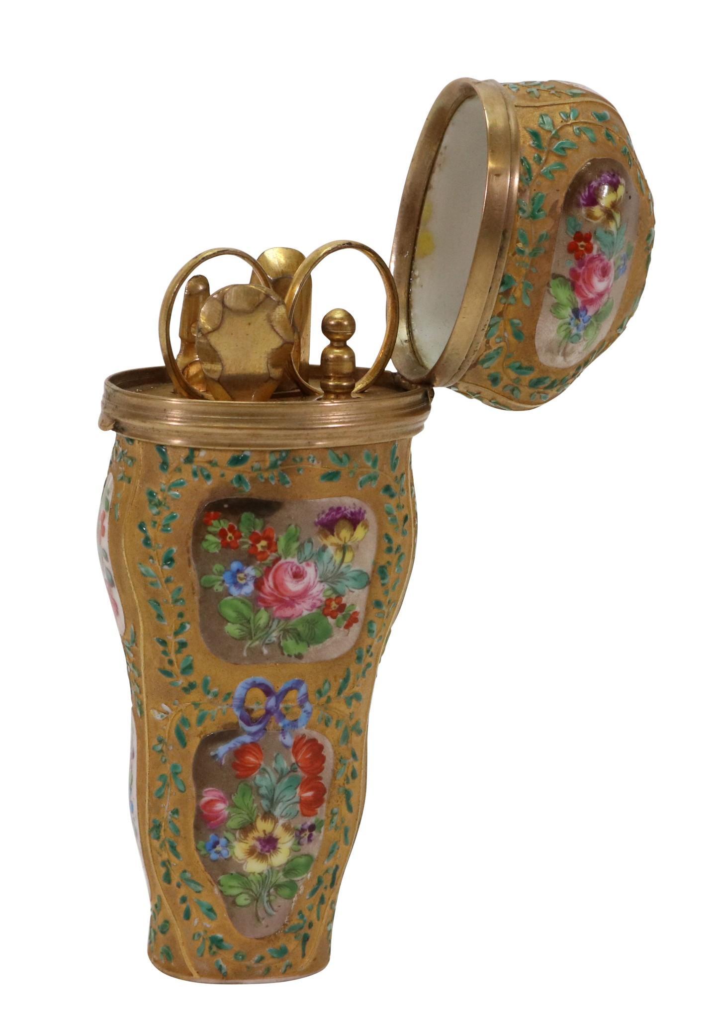 19th C. French Porcelain Etui: Hand painted floral panels and enamel festoons of ivy. Base is marked illegibly. Contents include needle case, scissors, file, stiletto, and button hook. 4.25"h