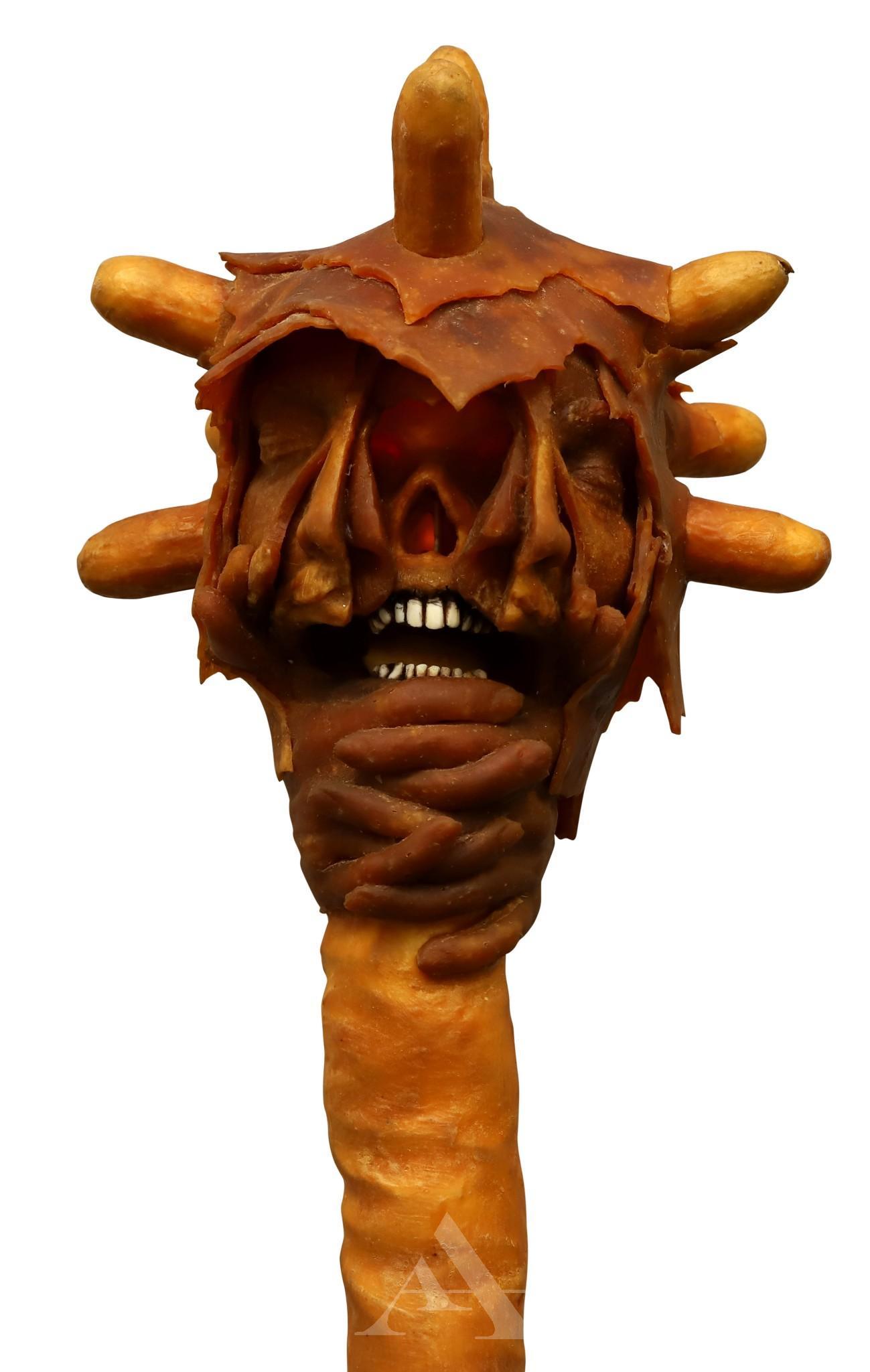 Wayne Forbes (1945-2013): Mixed media sculpture, unsigned. Surreal latex head with peeling layered face above hands clasping a "tail". Tail serves as an electrical cord (working order) for light bulb within head. Head measures