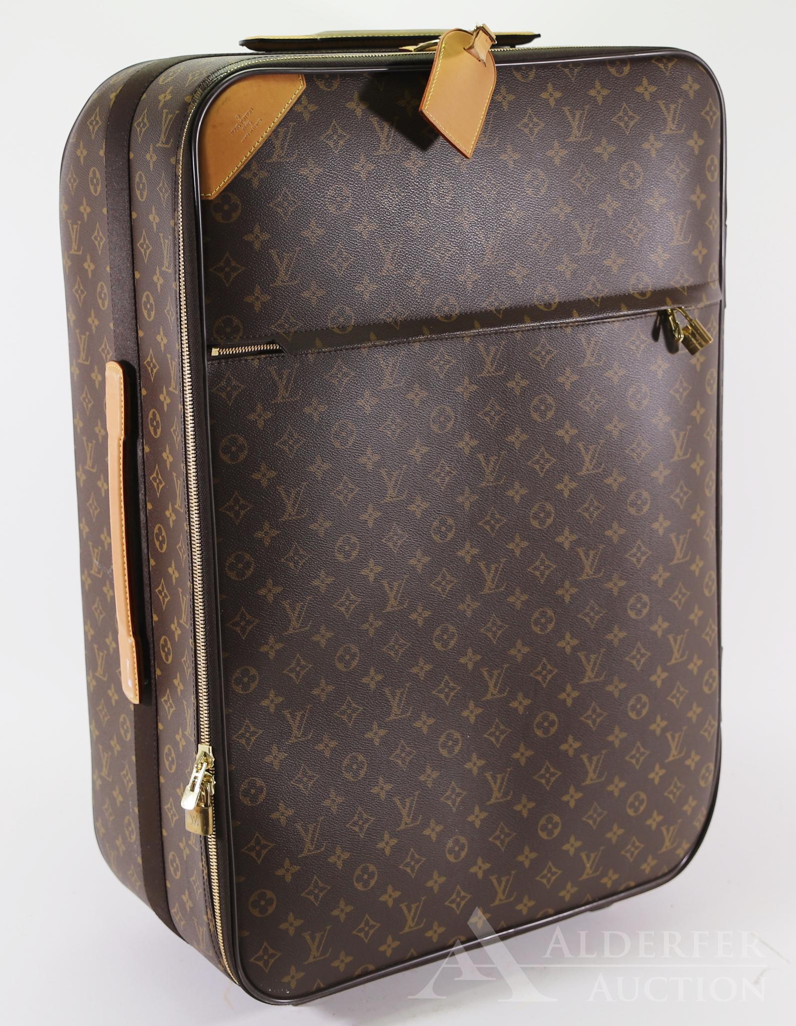 Louis Vuitton Rolling Luggage: Louis Vuitton rolling luggage with monogram canvas. Double zip closure with padlock, front zip pocket also with padlock, top and side leather handles and telescopic plastic handle and removable leathe