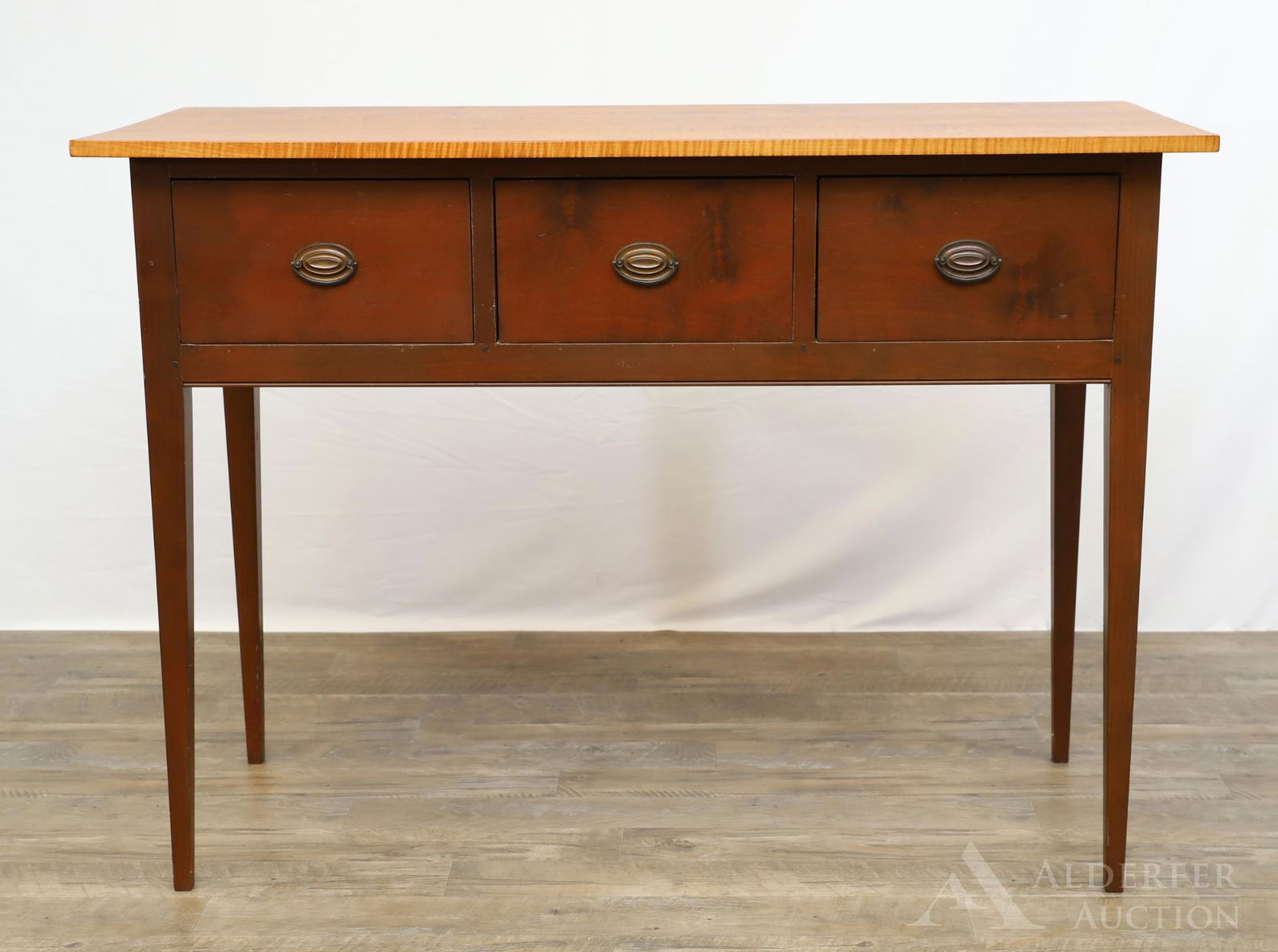 David T. Smith Hunt Board: Morrow, Ohio. Tiger maple and cherry, single board top over three drawers on tapered legs. 36"h x 49.5"w x 21"d