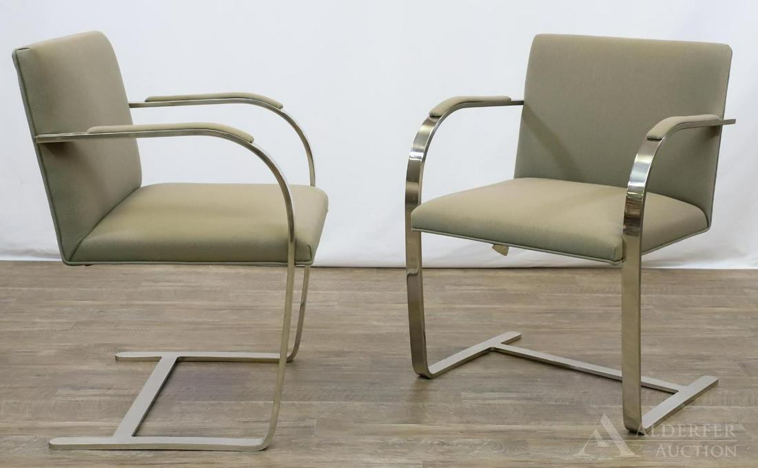 Mies van der Rohe BRNO Chairs for Knoll: Pair of stainless steel frames with rounded arms and stretcher base. Upholstered seat, back, and arms. Label underside. 31"h x 23"w x 17.5"d