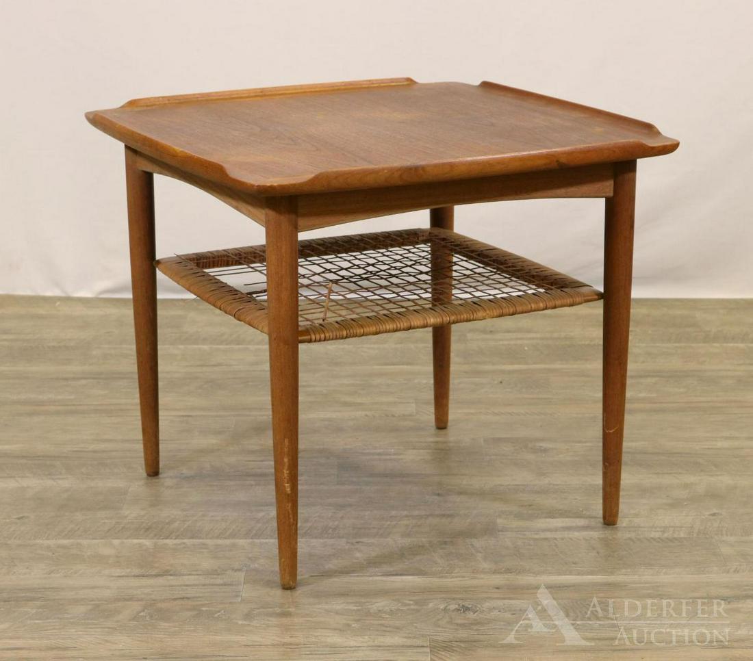 Paul Jensen for Selig Side Table: Two tier teak side table with lipped square top over cane shelf on tapered legs. Label underside. 21"h x 24" square