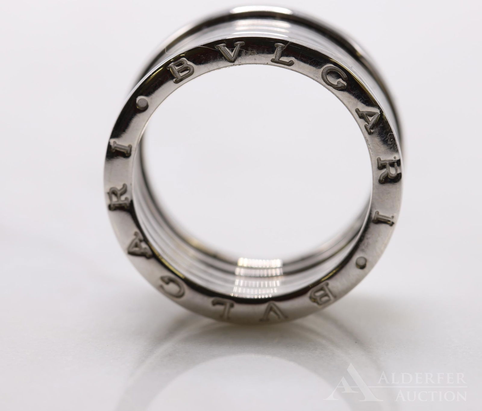 Bvlgari 18KW Gold Ring: 12.5mm wide, designed to expand width slightly. Size 9 1/2. 12.7gtw. Comes with original Bvlgari box.