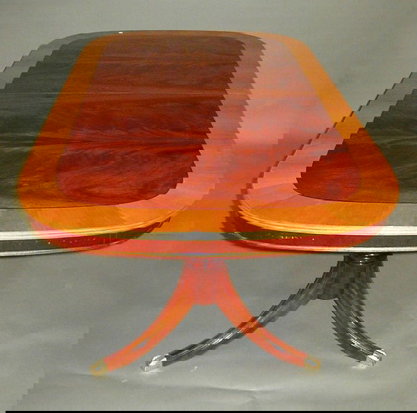 Mahogany & Cherrywood Extension Table: Crotch Mahogany & Cherrywood Extension Dining Table. Dark mahogany with 4" light cherrywood border. Two Duncan Phyfe-style turned pedestals in mahogany, with splayed supports ending in brass covers. T