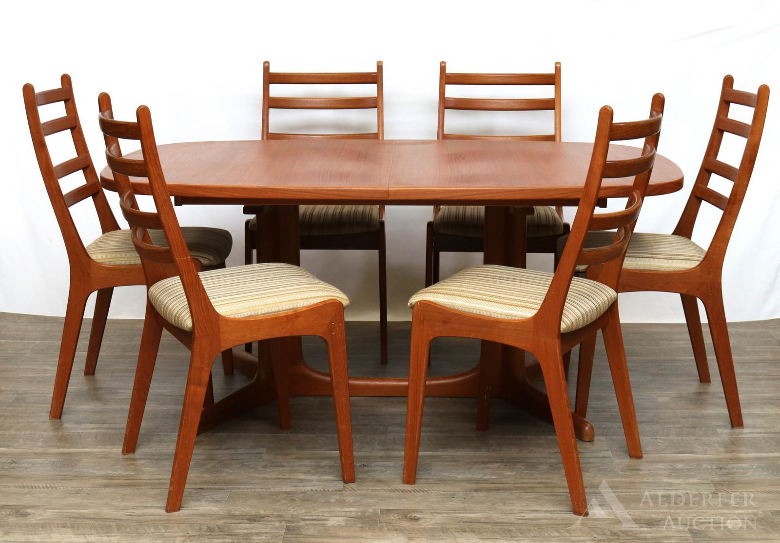 Attributed to Niels Moller Dining Room Suite: 7 p. Teak extending dining table with two leaves (19"w), 1960s. (6) Ladder back style chairs. Marked underside. Chairs 37"h x 19.5"w x 17.5"d and table 28"h x 63.75"w x 41.5"d